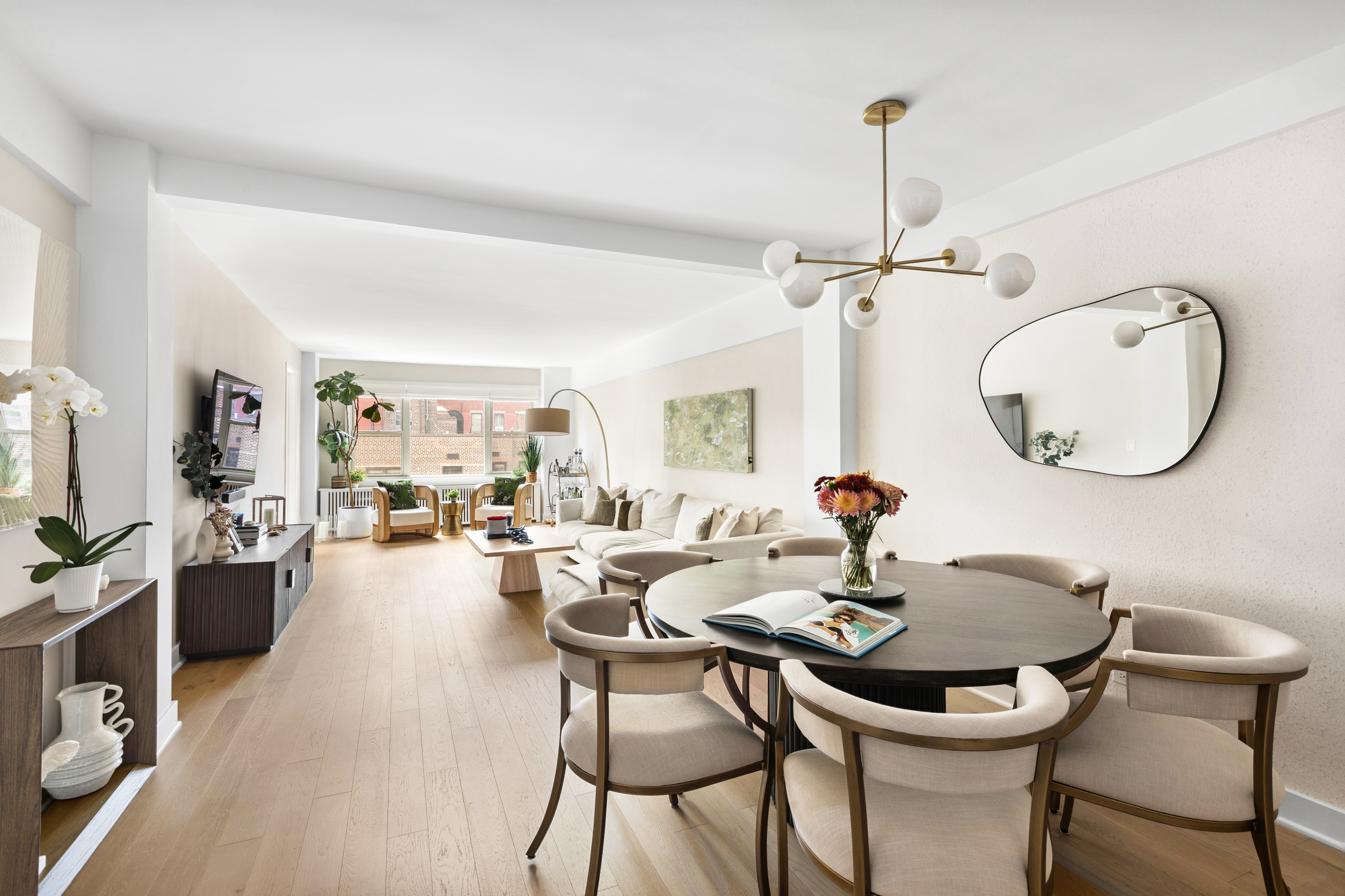 40 East 9th Street, Unit 7L Manhattan, NY 10003 - Photo 3 of 17 a dining room with furniture a chandelier and wooden floor