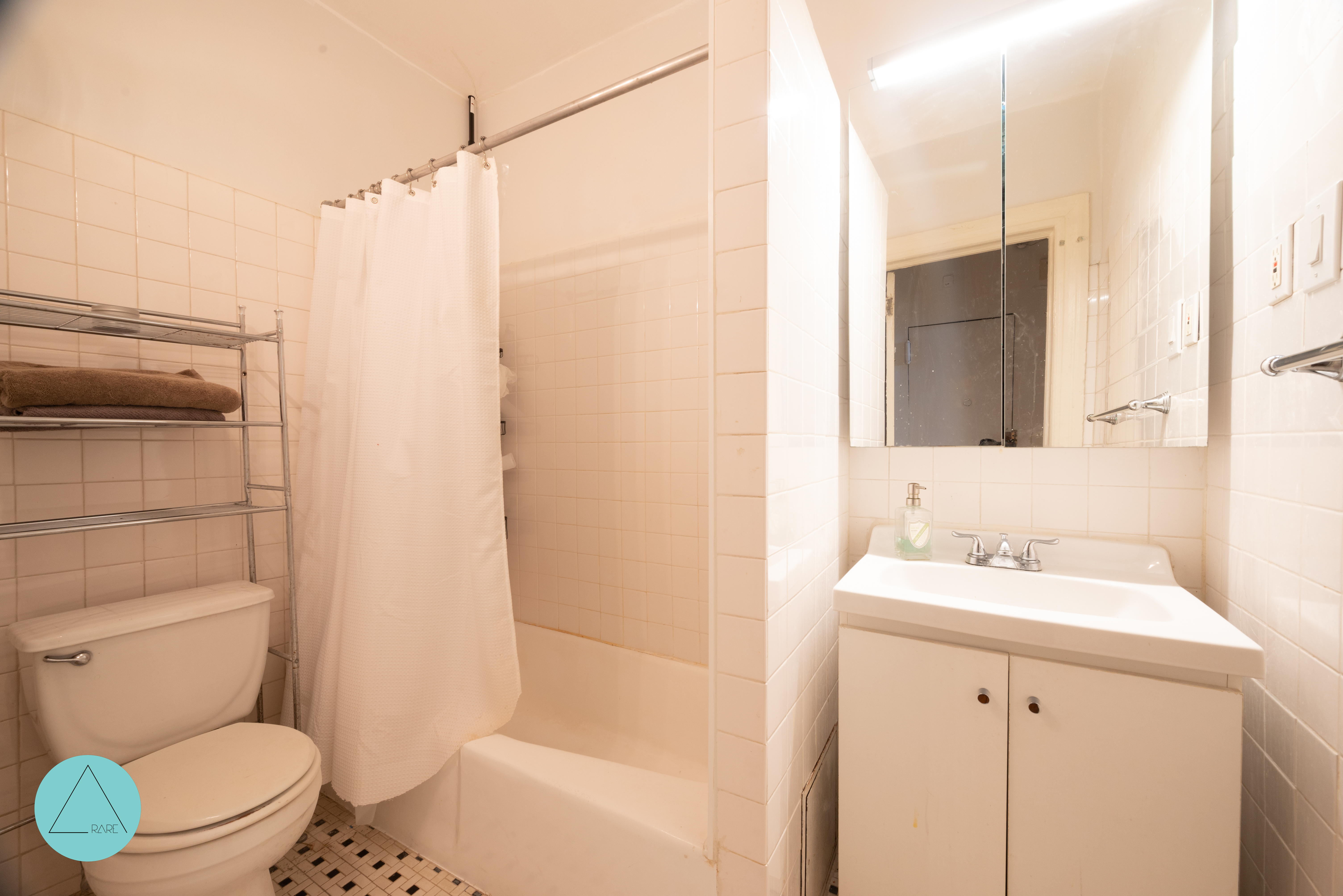 862 West End Avenue, Unit 4R Manhattan, NY 10025 - Photo 5 of 6 a bathroom with a sink a toilet and shower