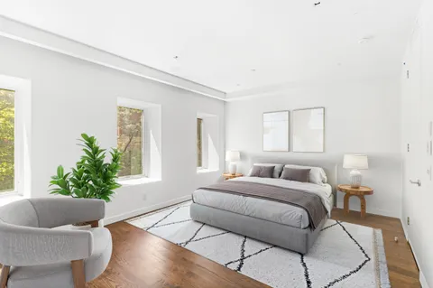 a bedroom with a bed and chair