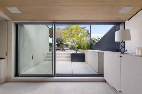a view of a living room and floor to ceiling window