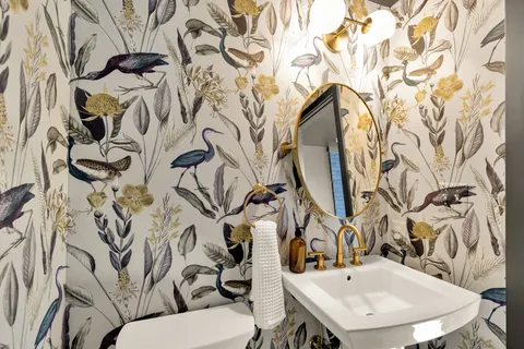 a bathroom with a sink and mirror with toilet