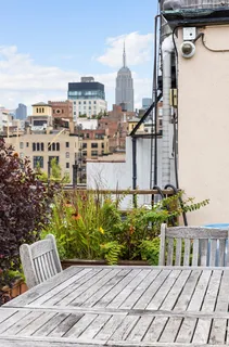 a view of a brick building with a bench in front of house