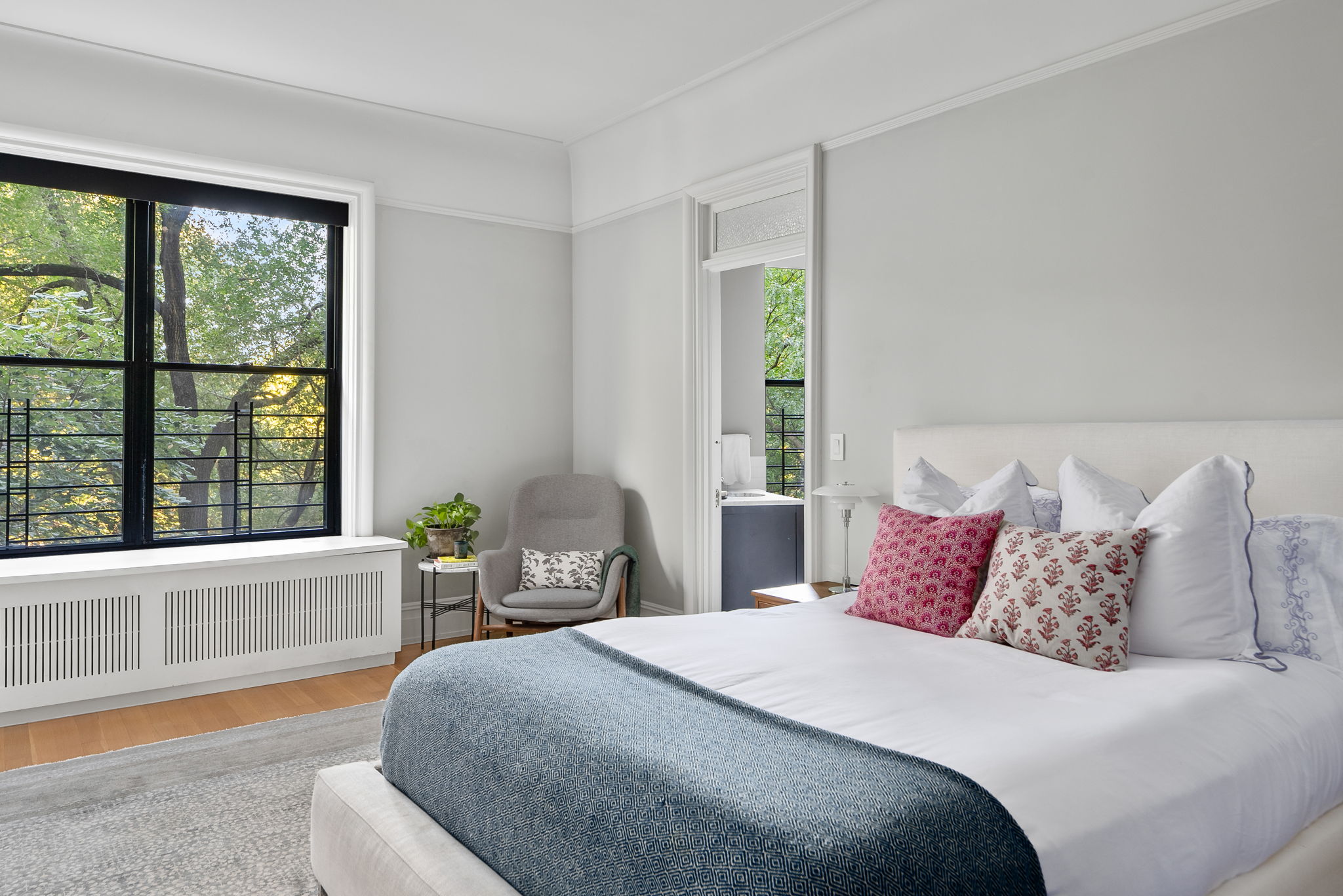 210 Riverside Drive, Unit 2E Manhattan, NY 10025 - Photo 6 of 15 a bedroom with a large bed and a large window