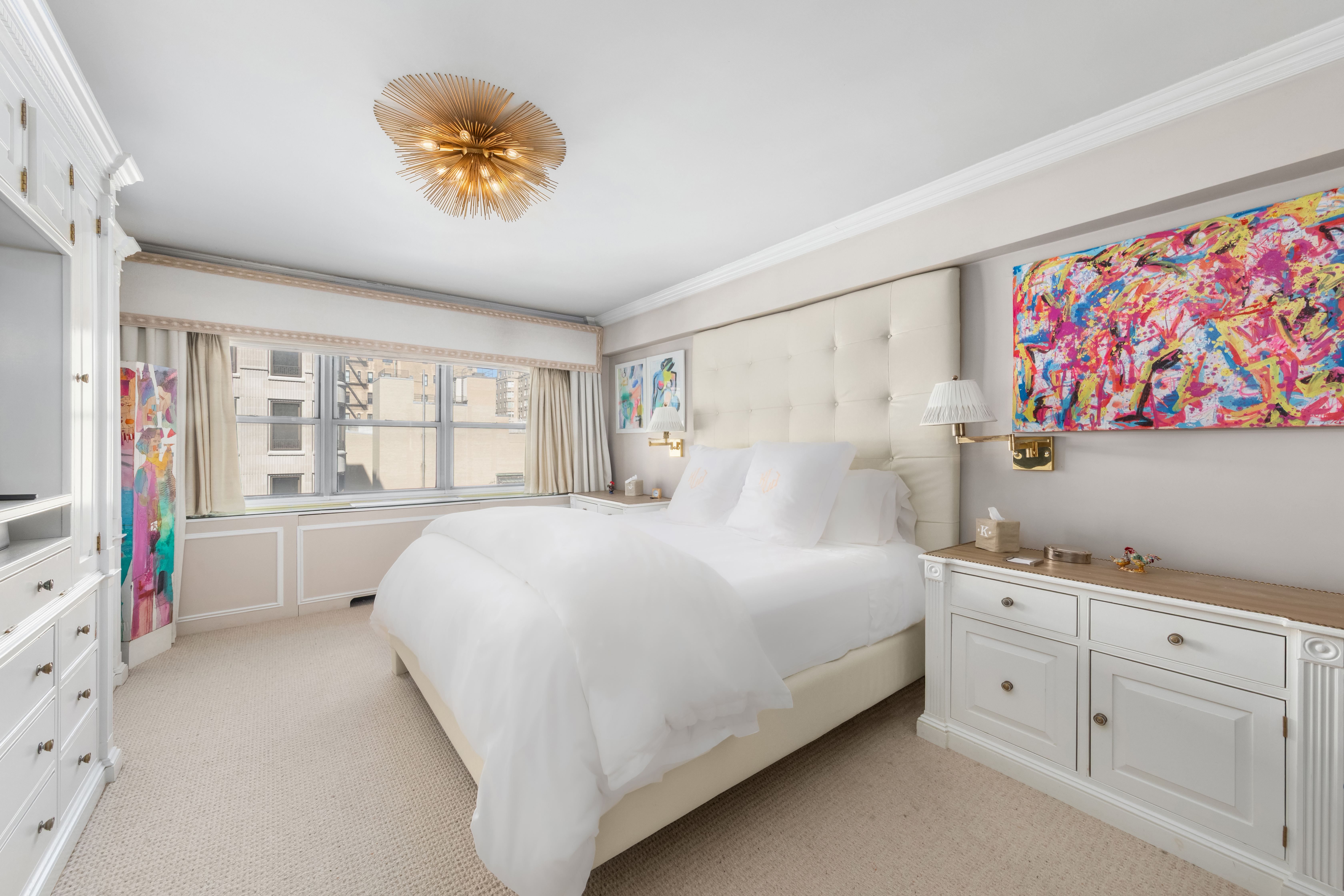 27 East 65th Street, Unit 10BC Manhattan, NY 10065 - Photo 6 of 16 a bedroom with a bed a large window with the outer view