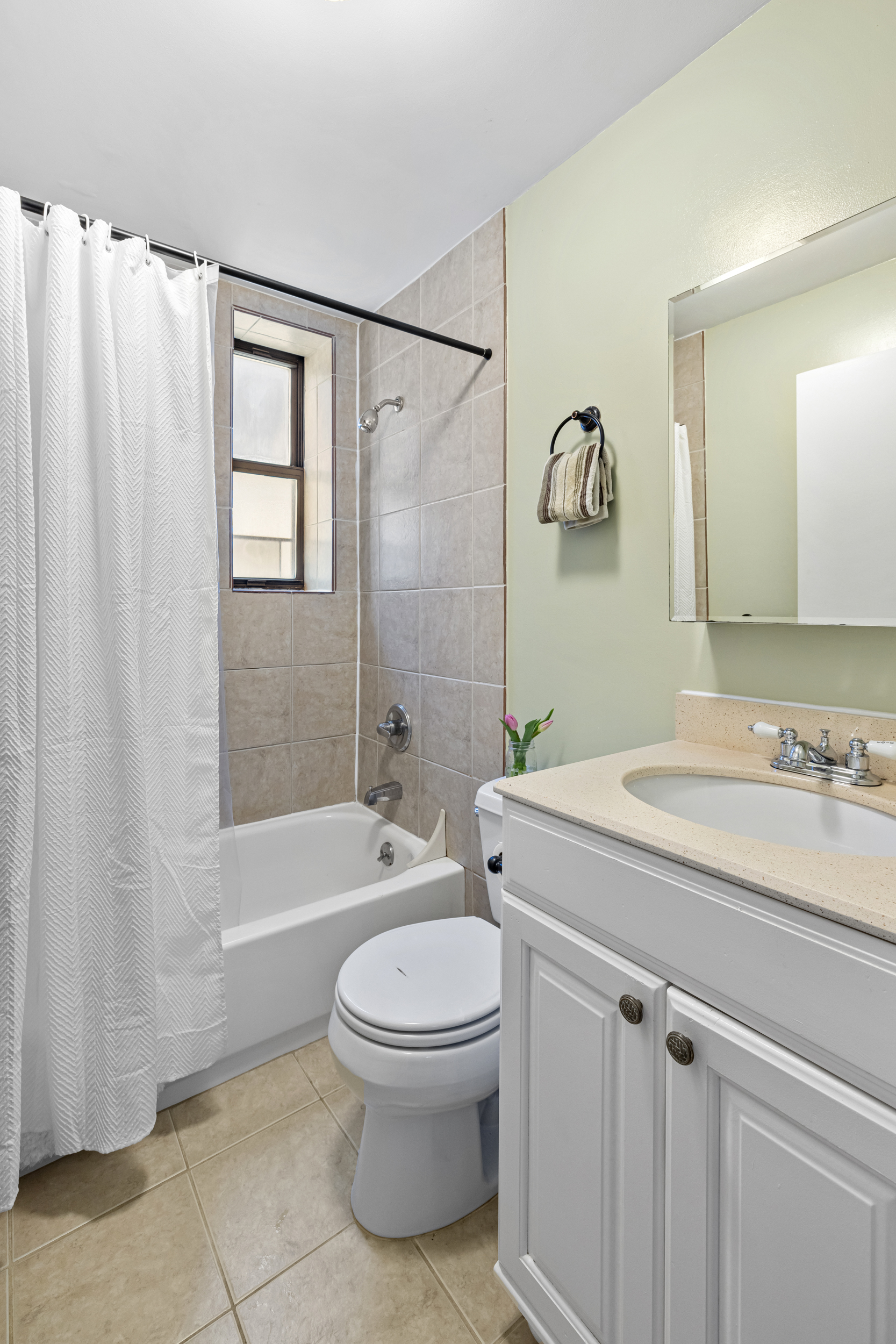 4 West 109th Street, Unit 6A Manhattan, NY 10025 - Photo 7 of 10 a bathroom with a sink a toilet and shower