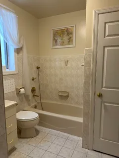 a bathroom with a toilet and a shower