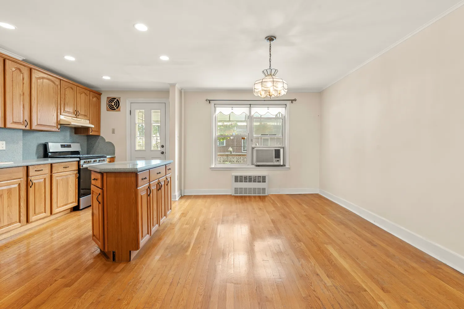 a view of a kitchen with a sink and wooden floor