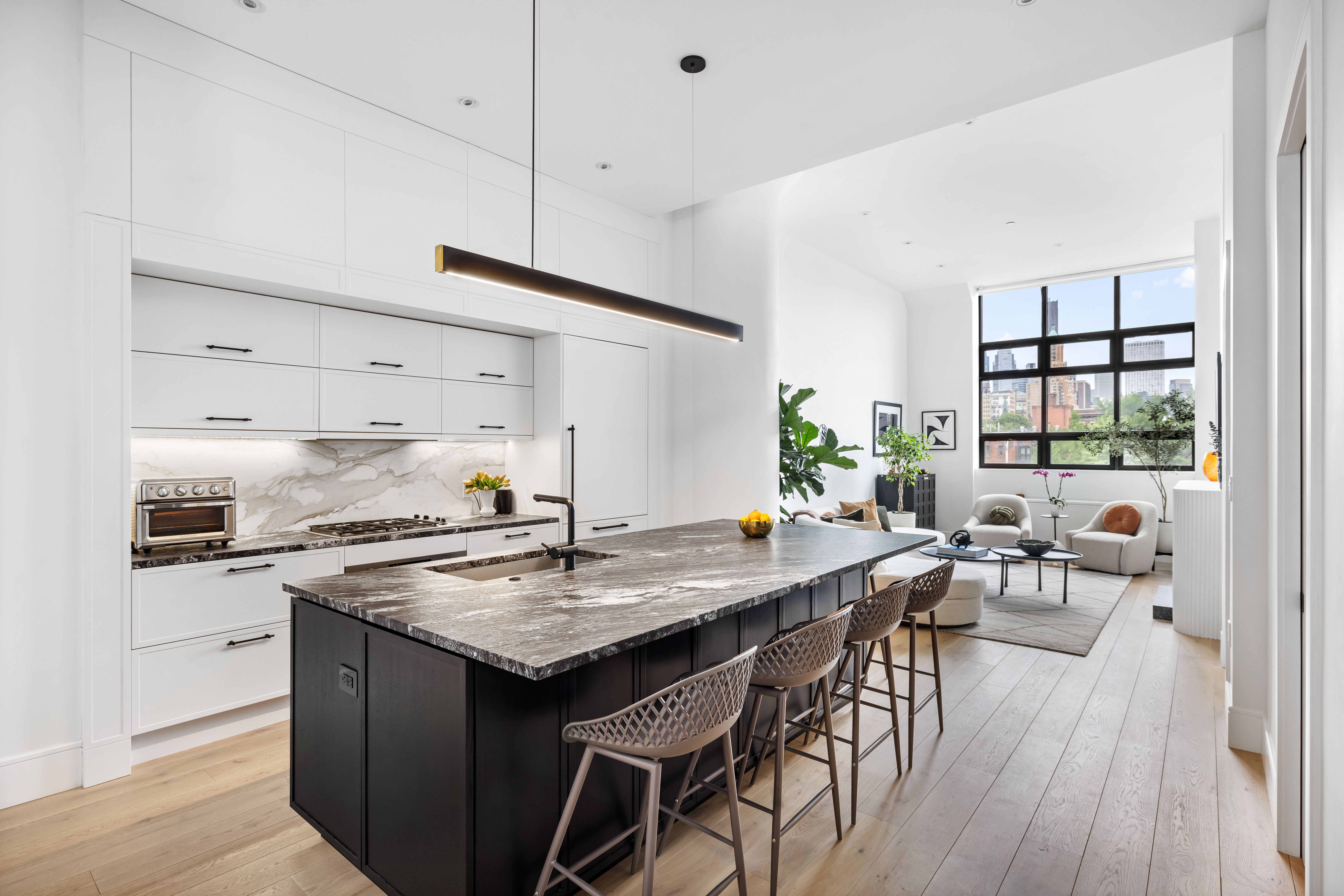 360 Furman Street, Unit 508 Brooklyn, NY 11201 - Photo 2 of 28 a kitchen with granite countertop a table chairs stove and wooden floor