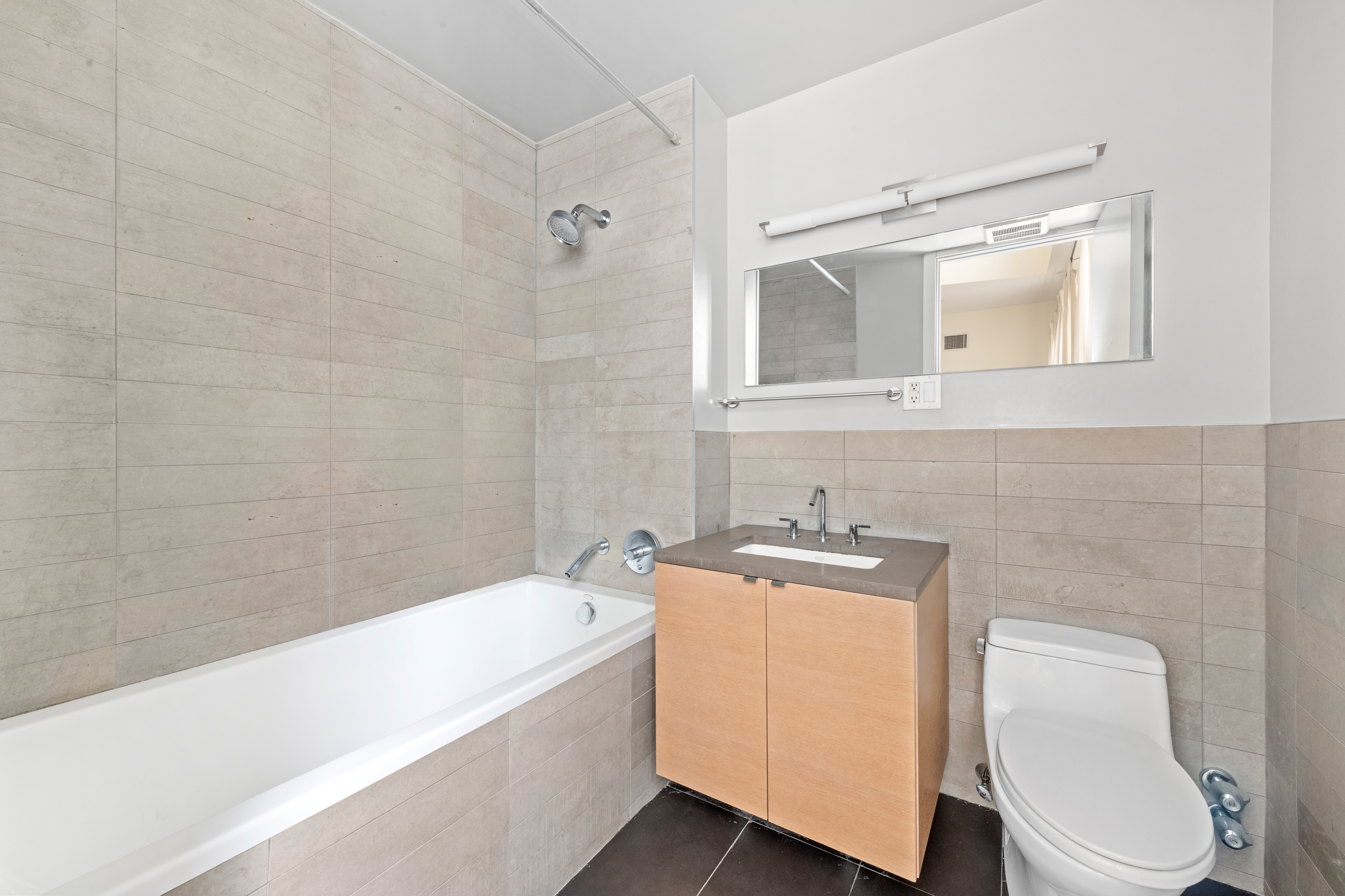 50 Bayard Street, Unit 3J Brooklyn, NY 11211 - Photo 3 of 13 a bathroom with a sink a toilet and bathtub