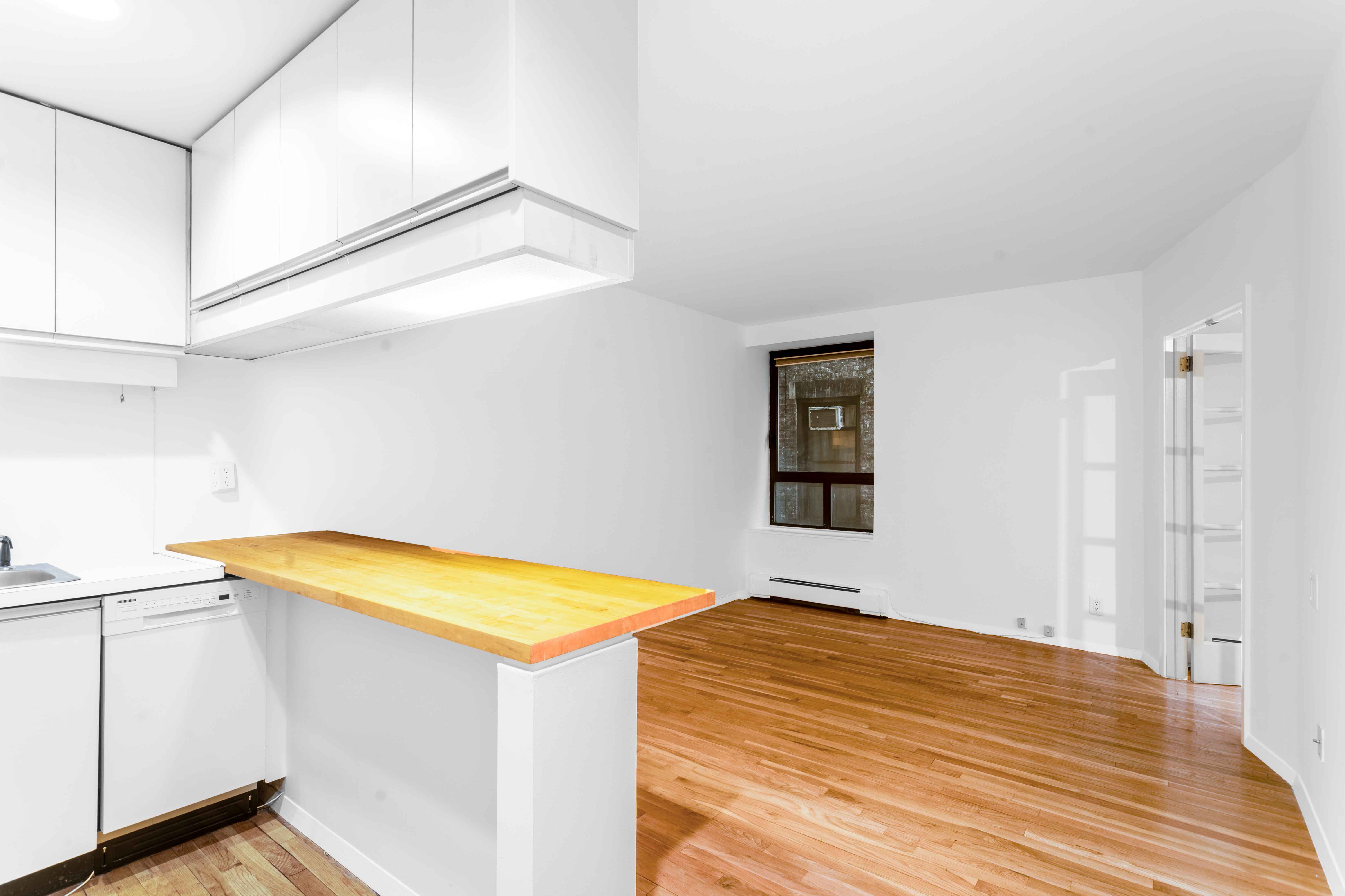 250 West 88th Street, Unit 408 Manhattan, NY 10024 - Photo 7 of 10 a view of a room with wooden floor and white walls