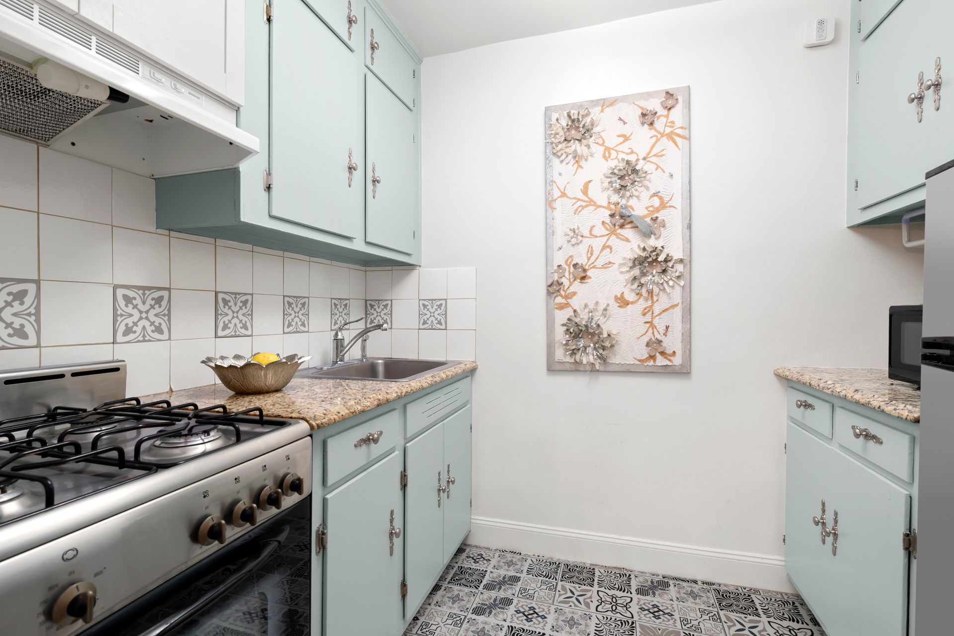 330 East 80th Street, Unit 2F Manhattan, NY 10075 - Photo 5 of 7 a kitchen with stainless steel appliances a stove a sink and cabinets