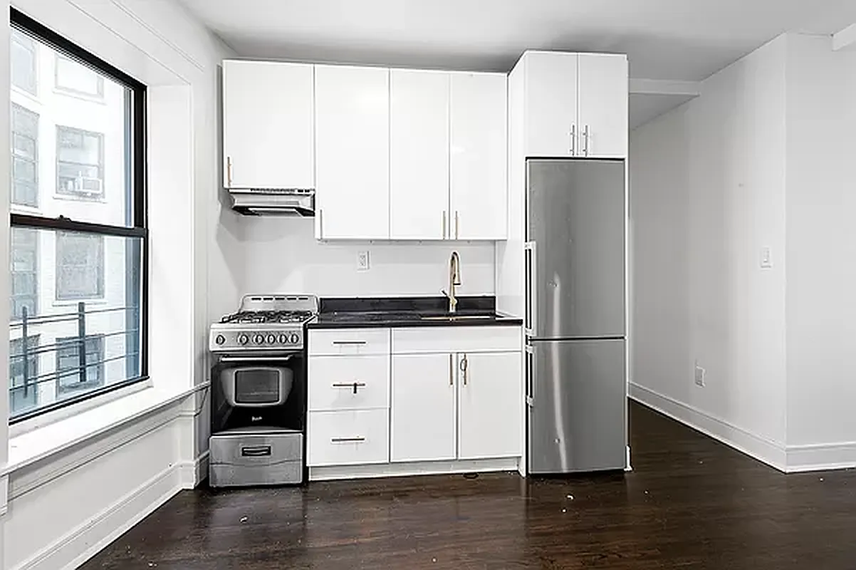 1392 Madison Avenue, Unit 15 Manhattan, NY 10128 - Photo 2 of 5 a kitchen with a refrigerator stove and wooden floor