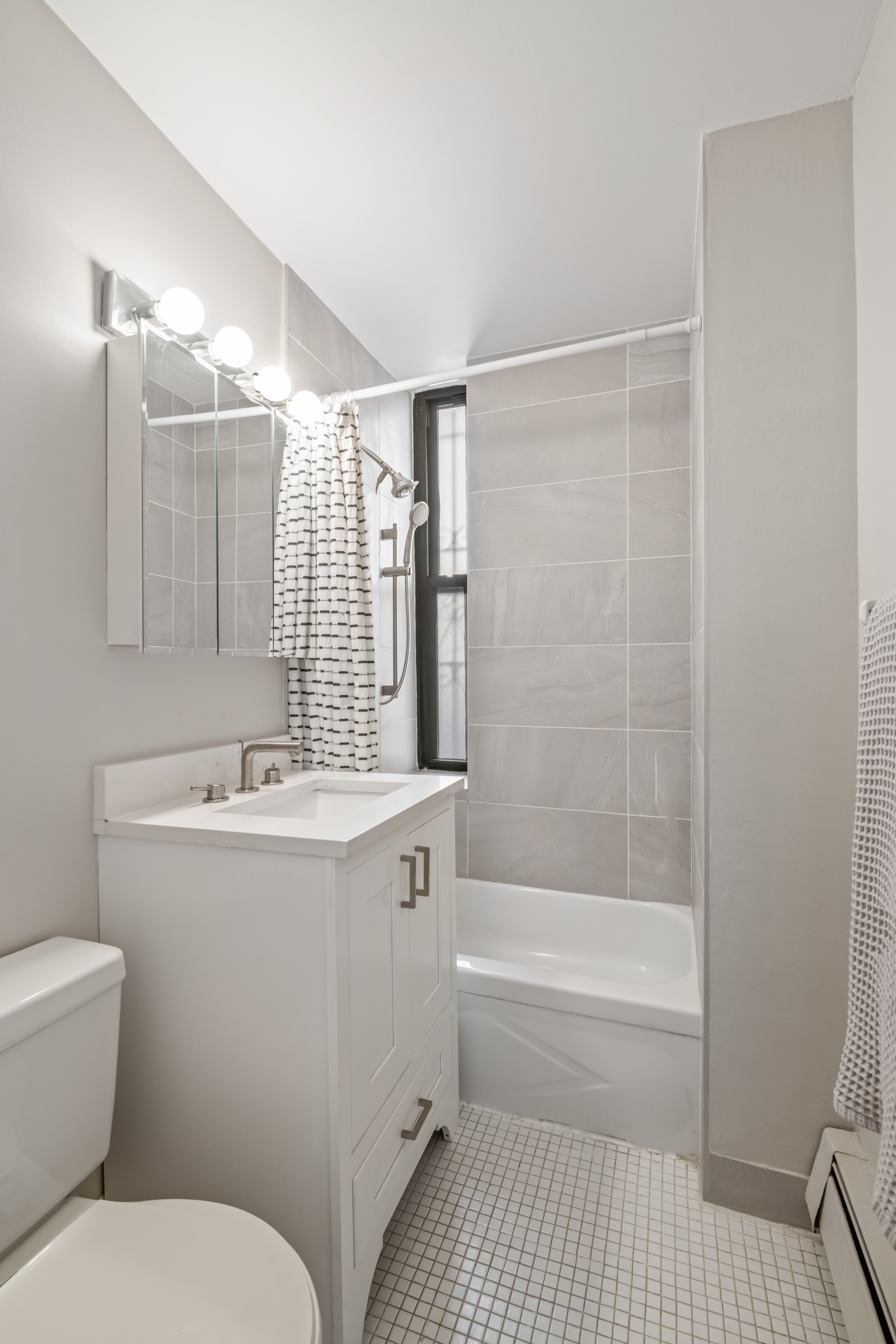 351 West 53rd Street, Unit 4E Manhattan, NY 10019 - Photo 8 of 9 a bathroom with a sink toilet and shower