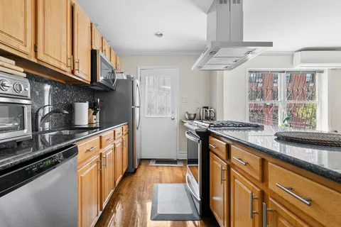 a kitchen with stainless steel appliances granite countertop a stove and a sink