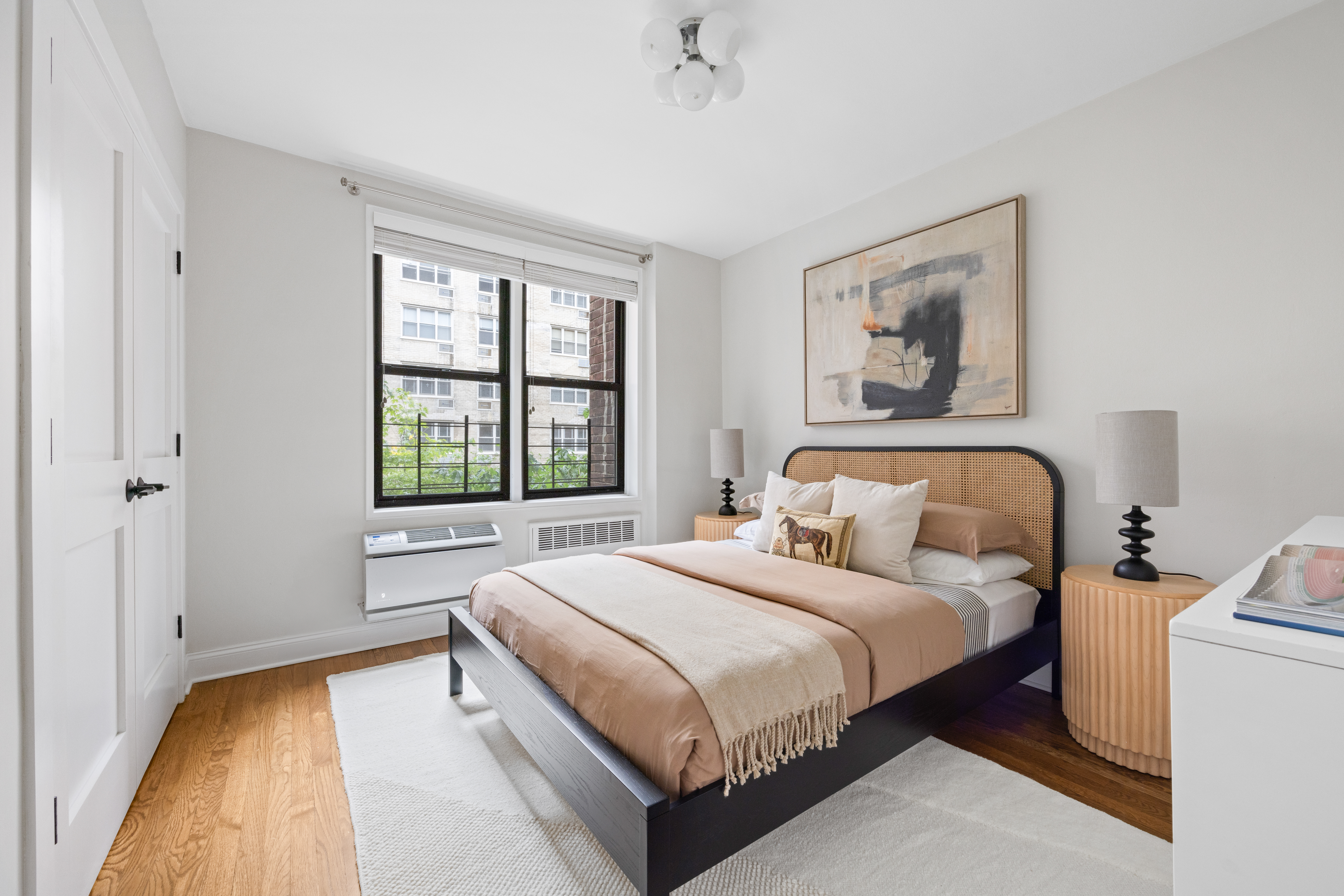 211 East 18th Street, Unit 2O Manhattan, NY 10003 - Photo 9 of 14 a bedroom with a bed and a large window