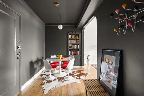 a bedroom with furniture and a book shelf