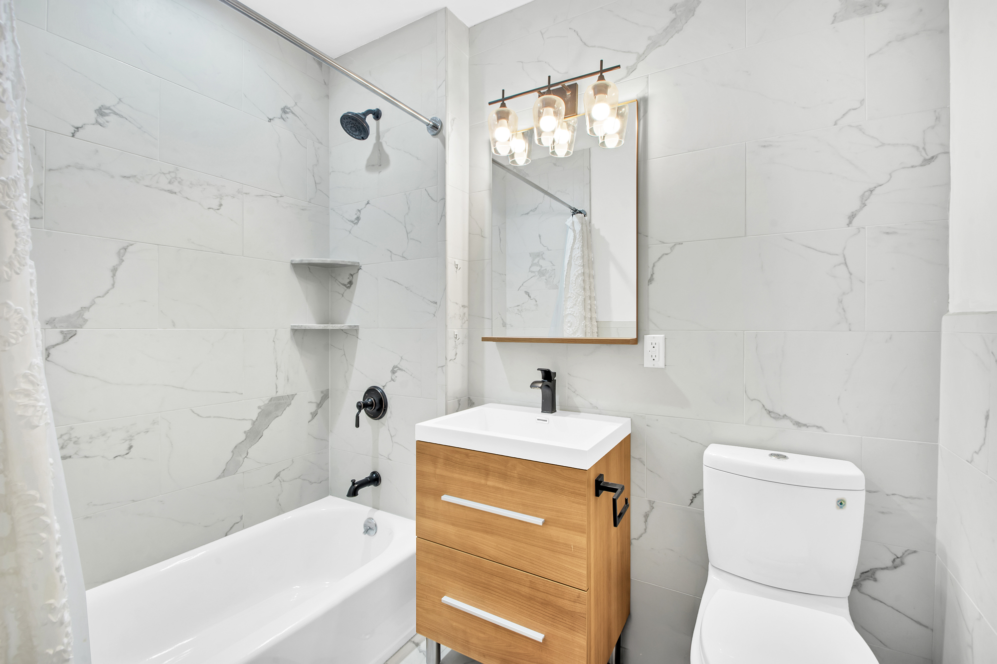 208 West 122nd Street Manhattan, NY 10027 - Photo 19 of 22 a bathroom with a sink toilet vanity and tub