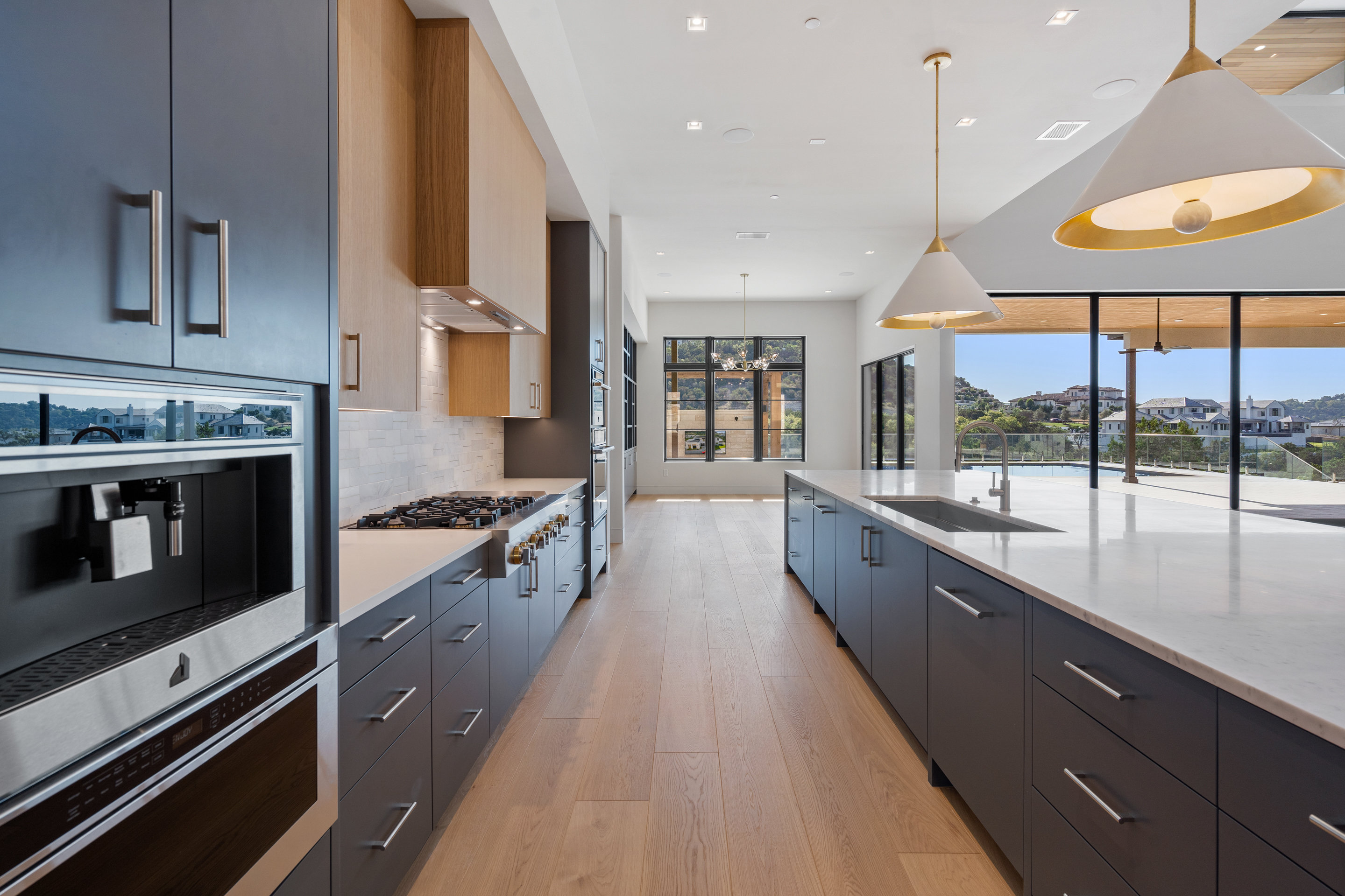 1905 Hallam Drive Austin, TX 78746 - Photo 12 of 39 a large kitchen with stainless steel appliances kitchen island a large counter tops and a large window