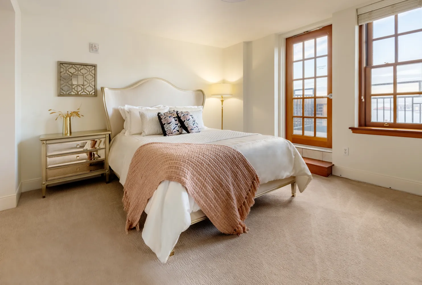 a spacious bedroom with a bed and a window