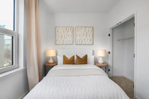 a bedroom with a bed and window