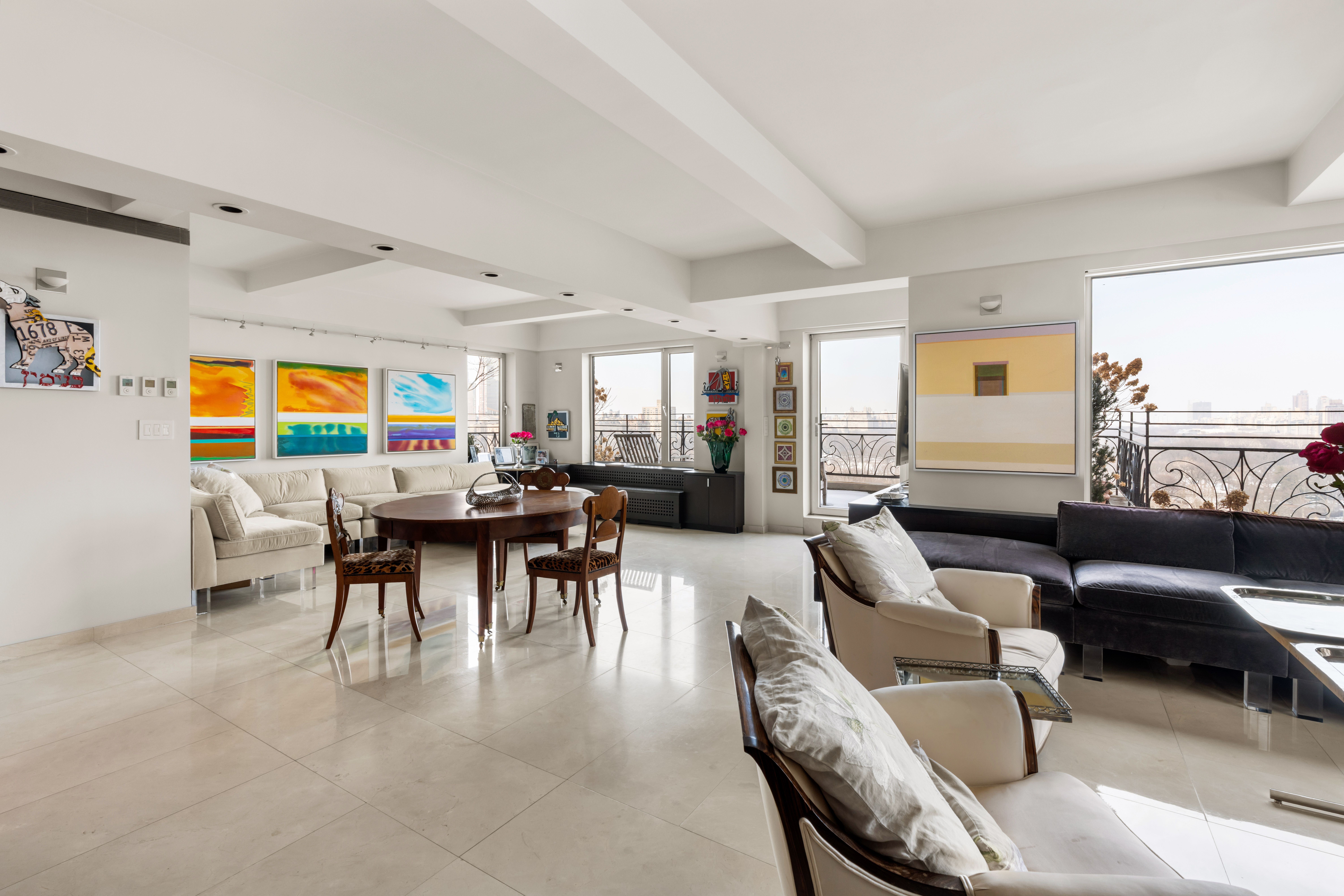 120 Central Park South, Unit PHE/W Manhattan, NY 10019 - Photo 1 of 11 a living room with furniture and a large window