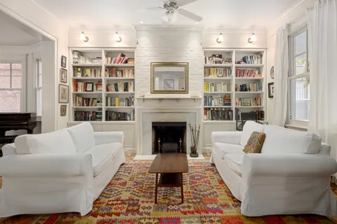 a living room with furniture fireplace and cabinet