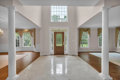 a view of entryway and hall with wooden floor