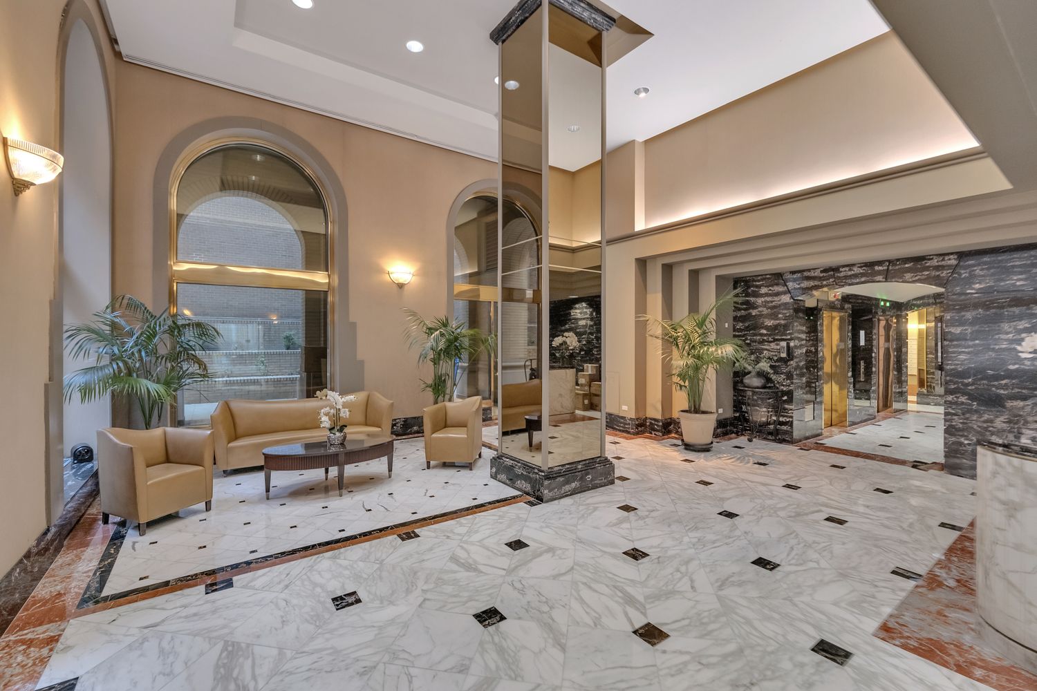 a living room with furniture a fireplace and potted plants
