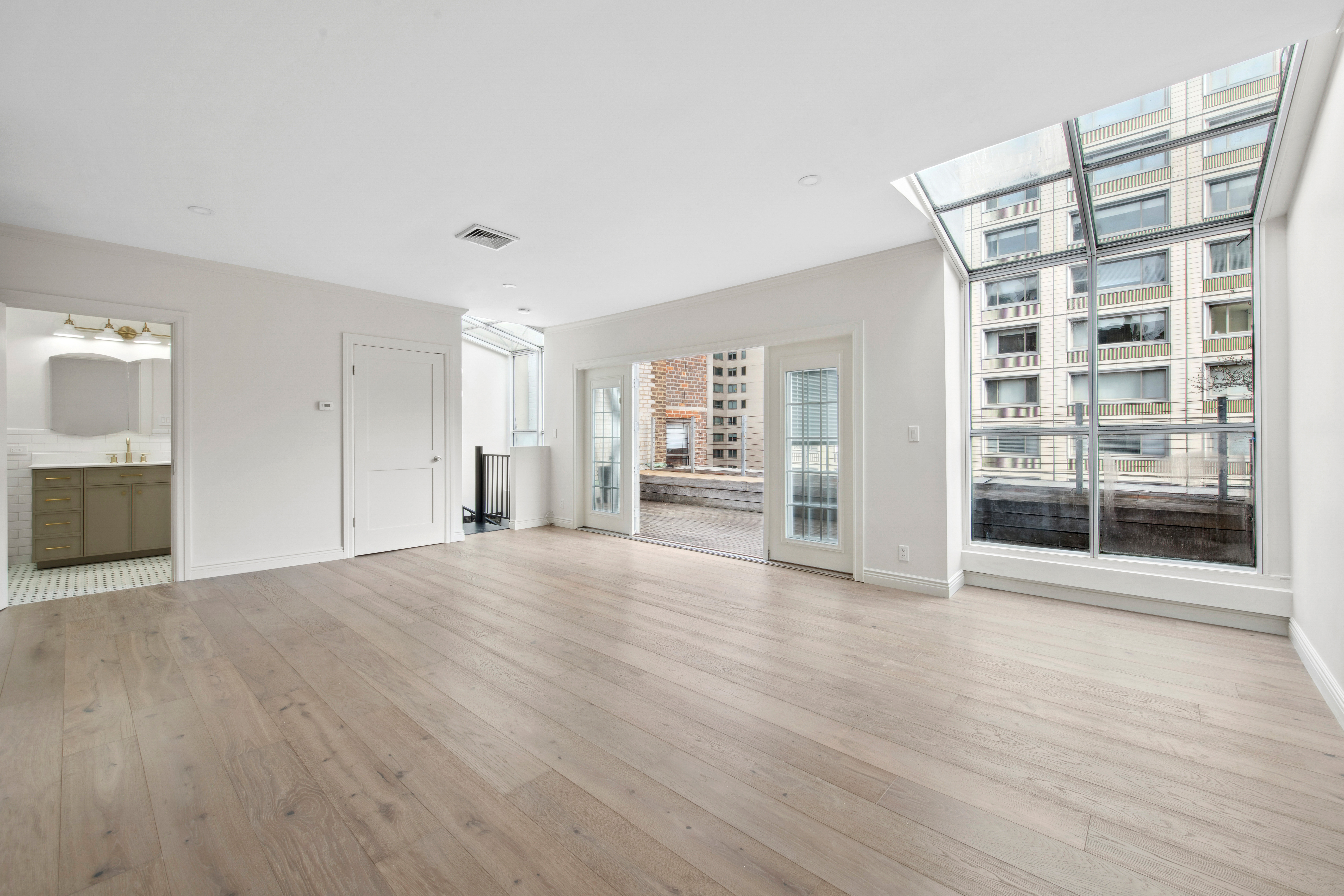 212 East 70th Street, Unit 4B Manhattan, NY 10021 - Photo 9 of 16 a view of an empty room with wooden floor and a cabinet