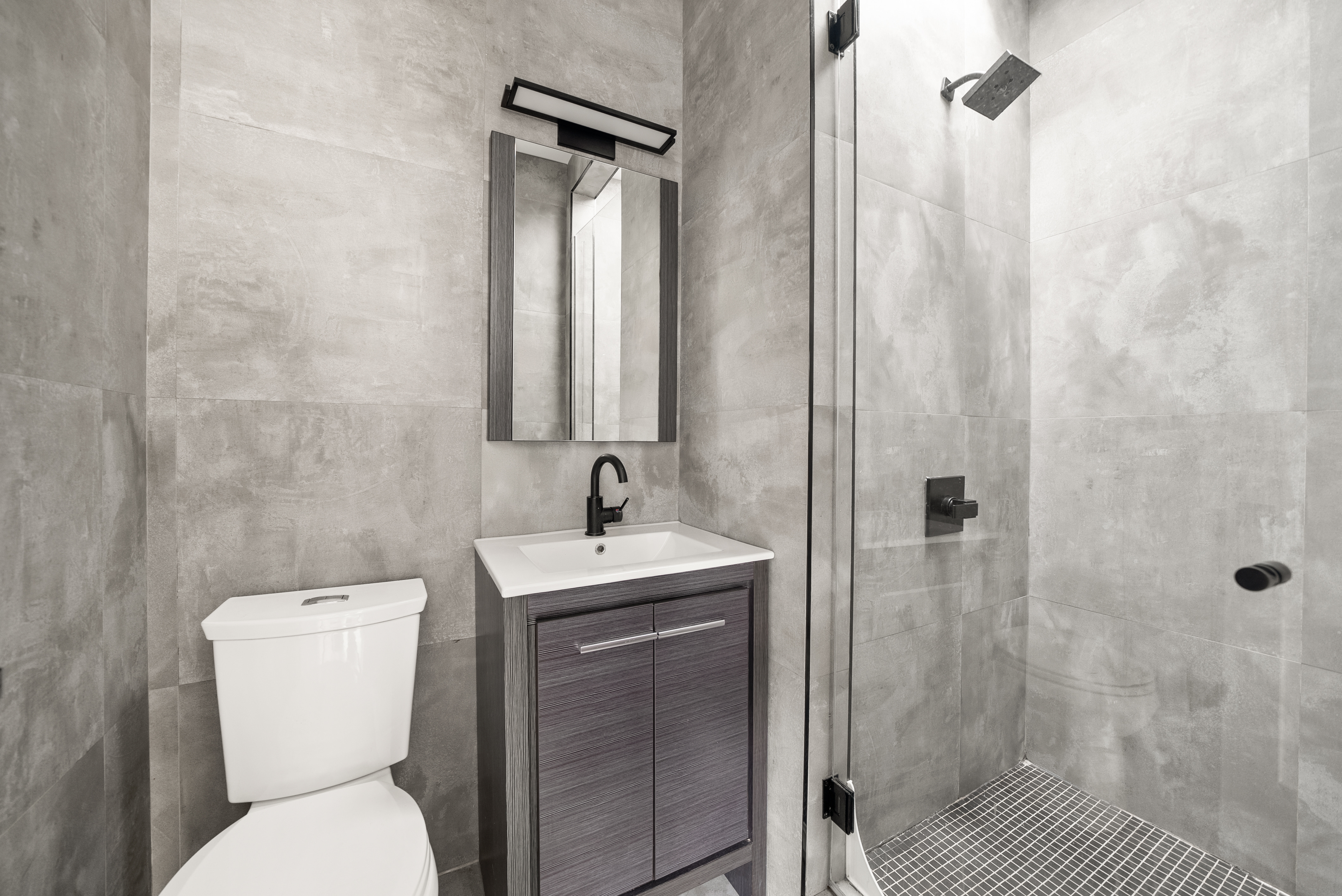 275 Bleecker Street, Unit 4 Manhattan, NY 10014 - Photo 8 of 10 a bathroom with a toilet a sink and shower