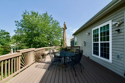 a view of deck with table and chairs and wooden floor