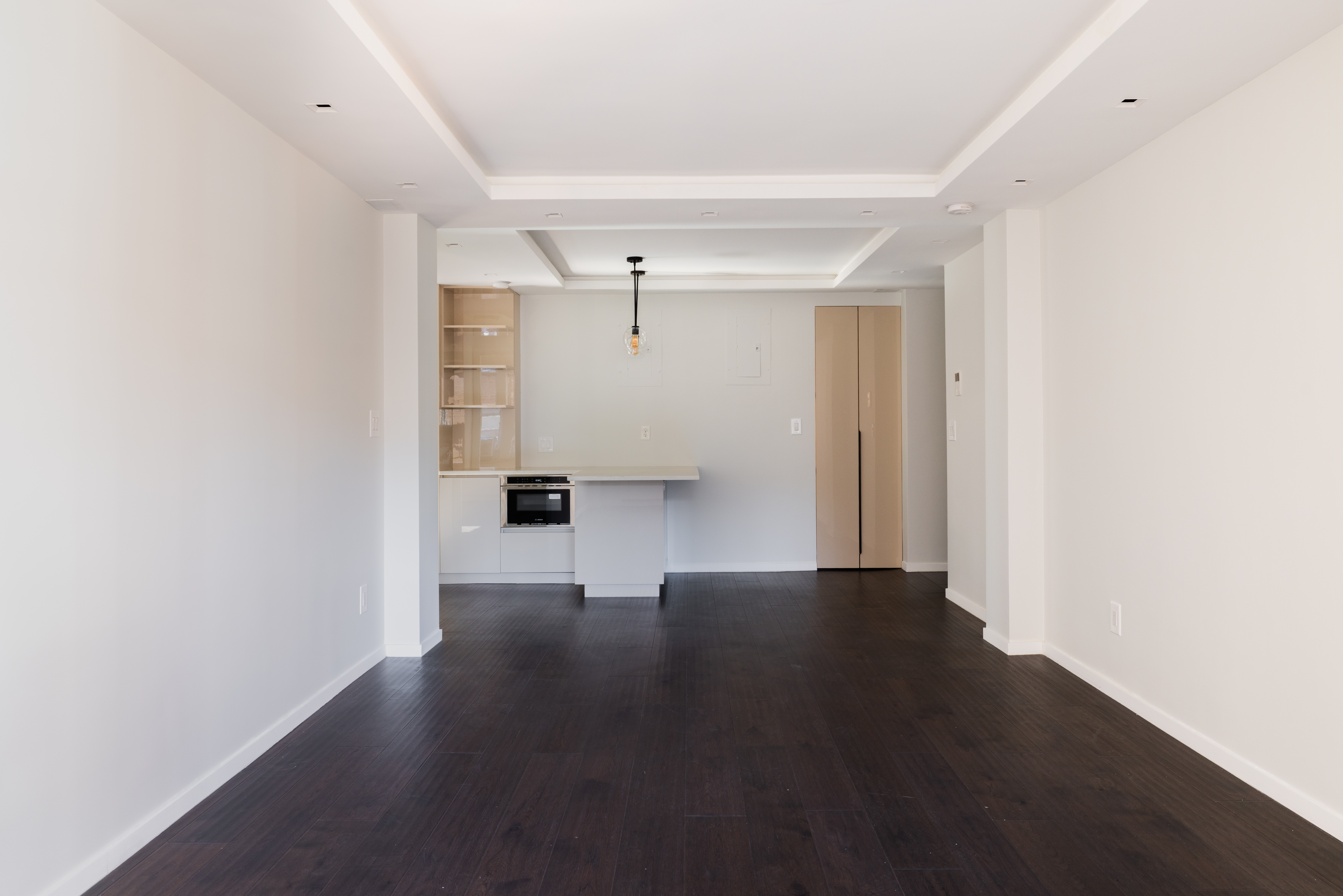 71-36 110th Street, Unit 4C Queens, NY 11375 - Photo 4 of 14 a view of an empty room with wooden floor and a window