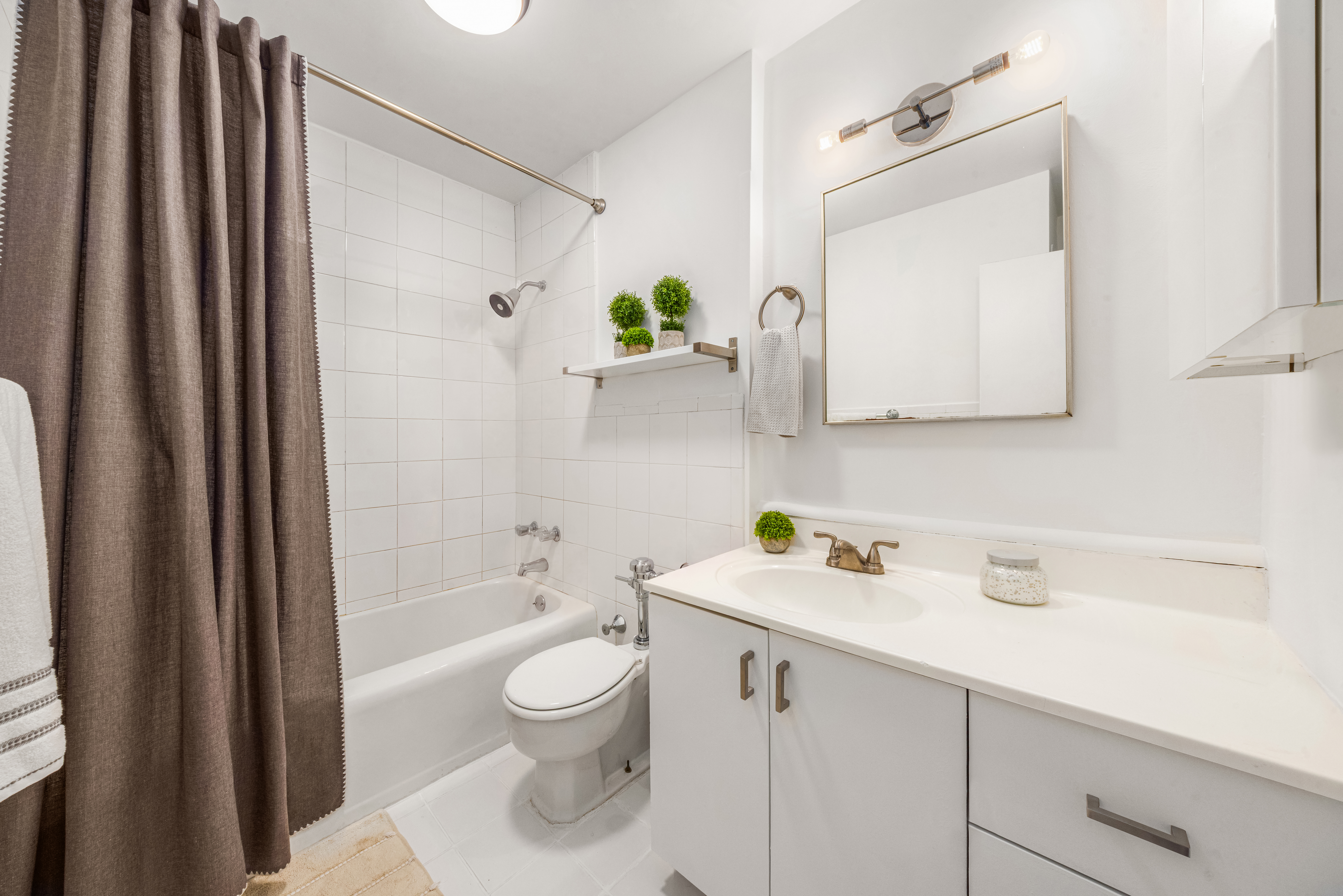 150 East 61st Street, Unit 2A Manhattan, NY 10065 - Photo 8 of 9 a bathroom with a sink a toilet and shower
