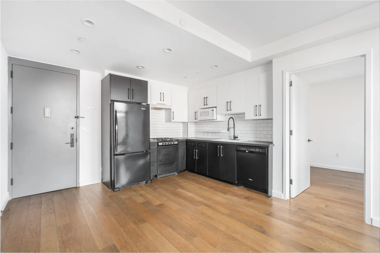 a kitchen with a refrigerator and a sink