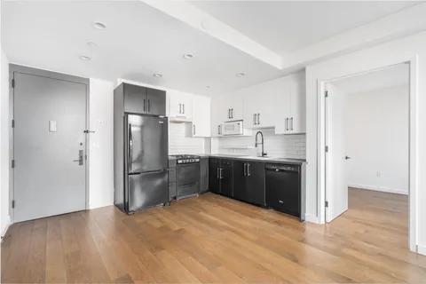 a kitchen with a refrigerator and a sink