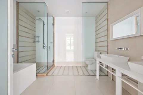 a bathroom with a sink a toilet and shower