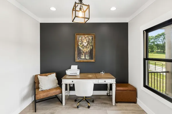a large kitchen with kitchen island a stove a sink a microwave a refrigerator and cabinets