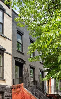 front view of a house with a tree