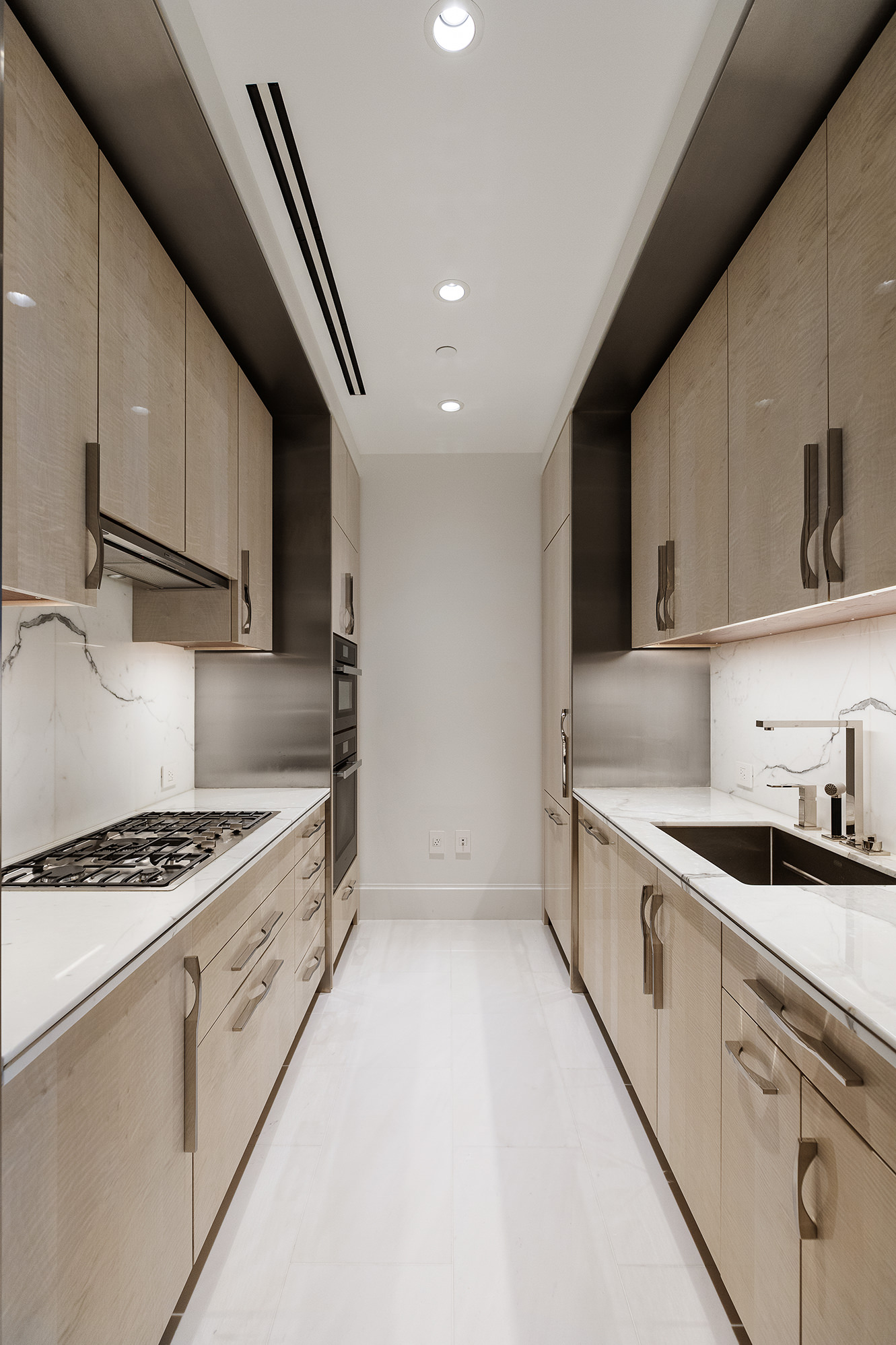 217 West 57th Street, Unit 57N Manhattan, NY 10019 - Photo 5 of 10 a kitchen with granite countertop a sink stove and cabinets