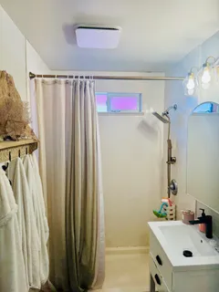 a bathroom with a sink vanity and tub