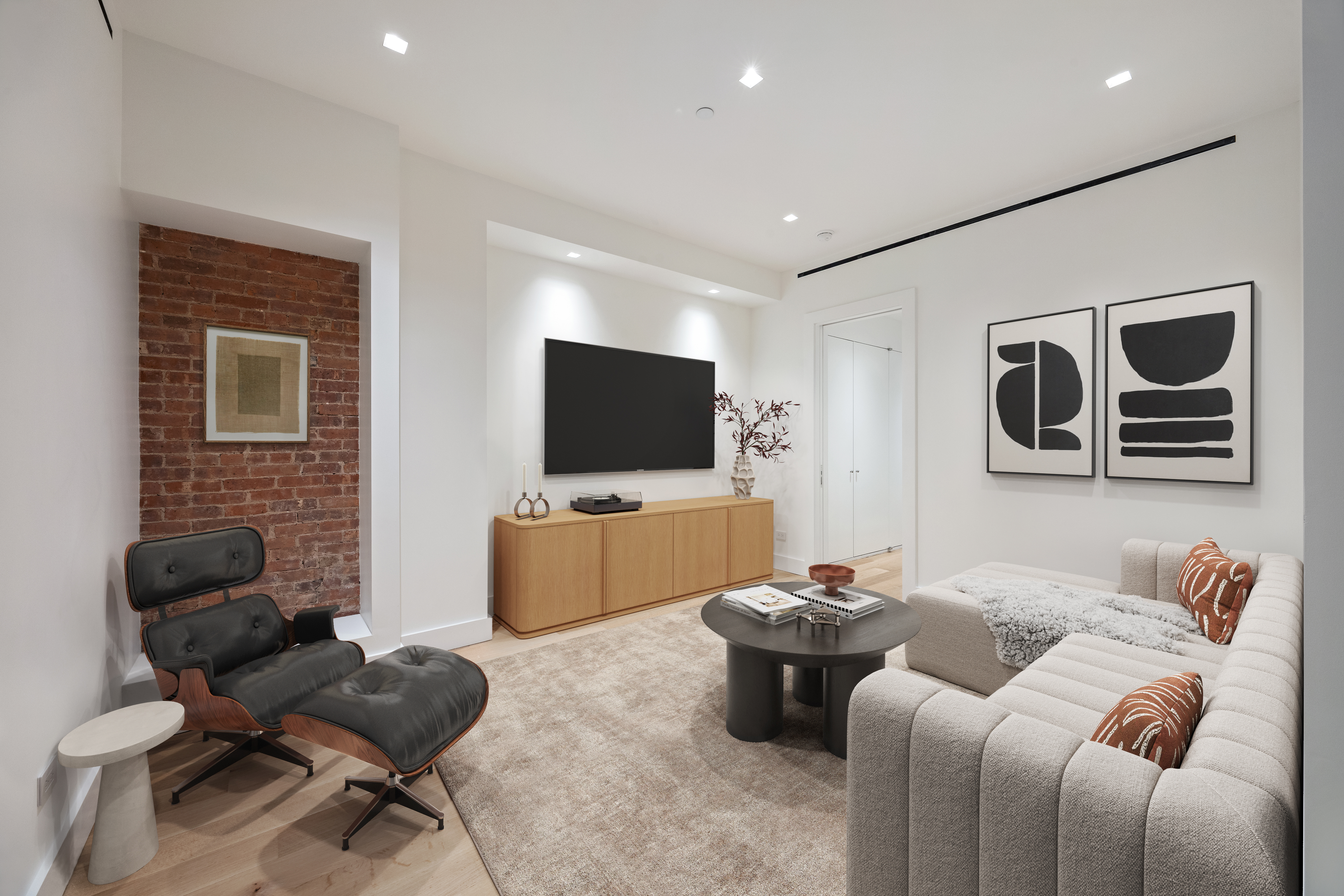 243 West Broadway, Unit 3 Manhattan, NY 10013 - Photo 20 of 25 a living room with furniture and a flat screen tv