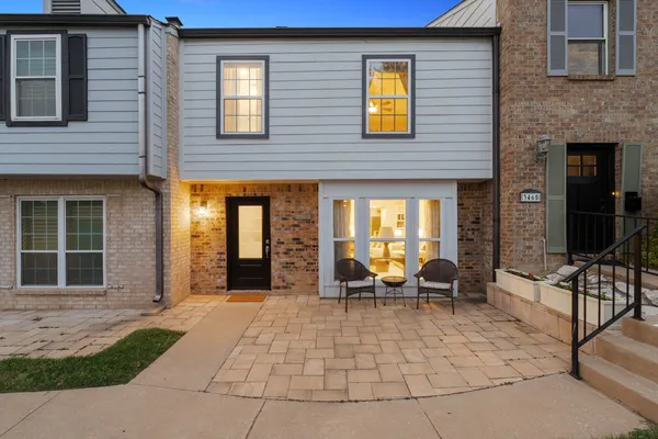 a view of a house with backyard and sitting area
