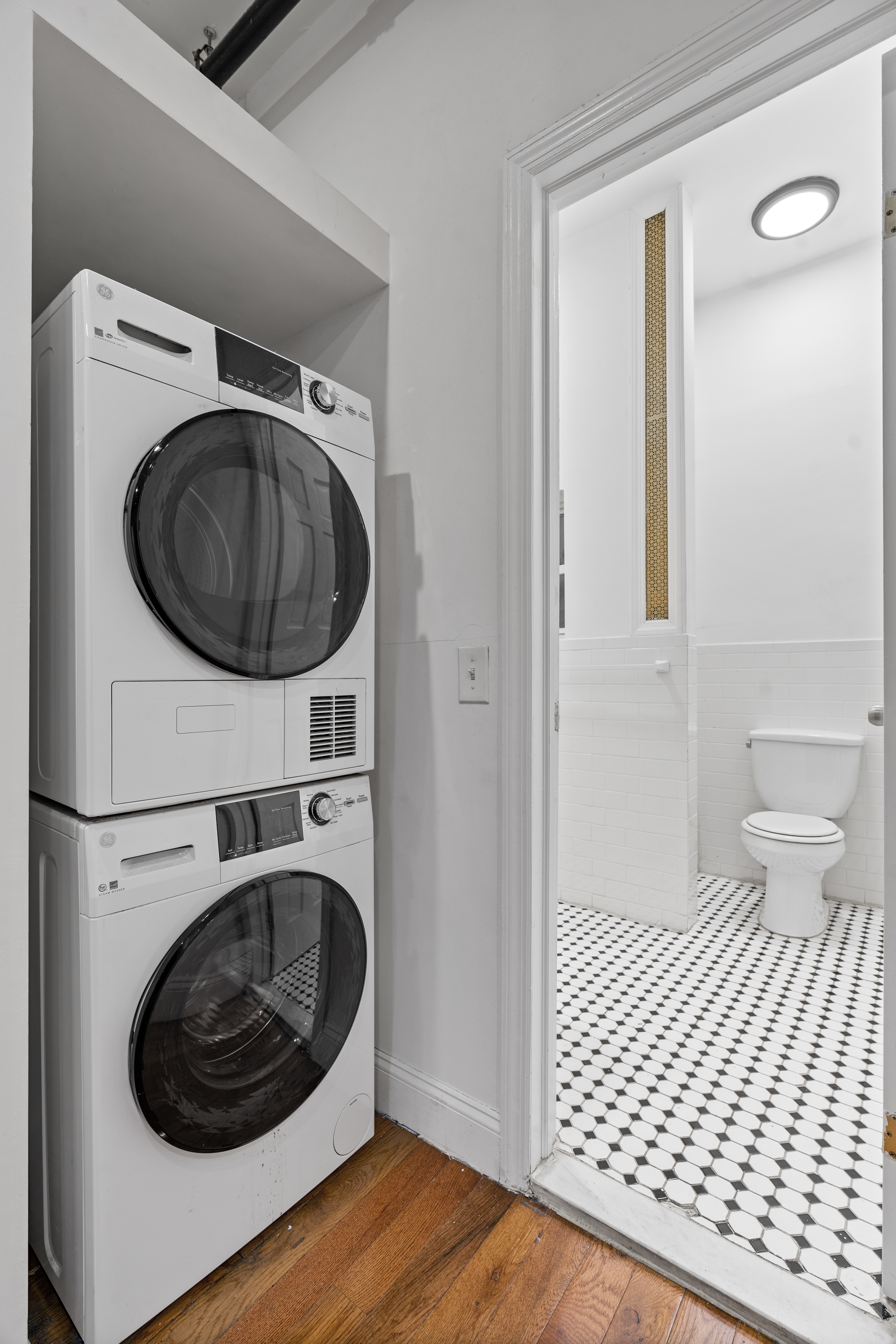 31 St Marks Place, Unit 1 Manhattan, NY 10003 - Photo 10 of 11 a bathroom with a toilet and a washing machine