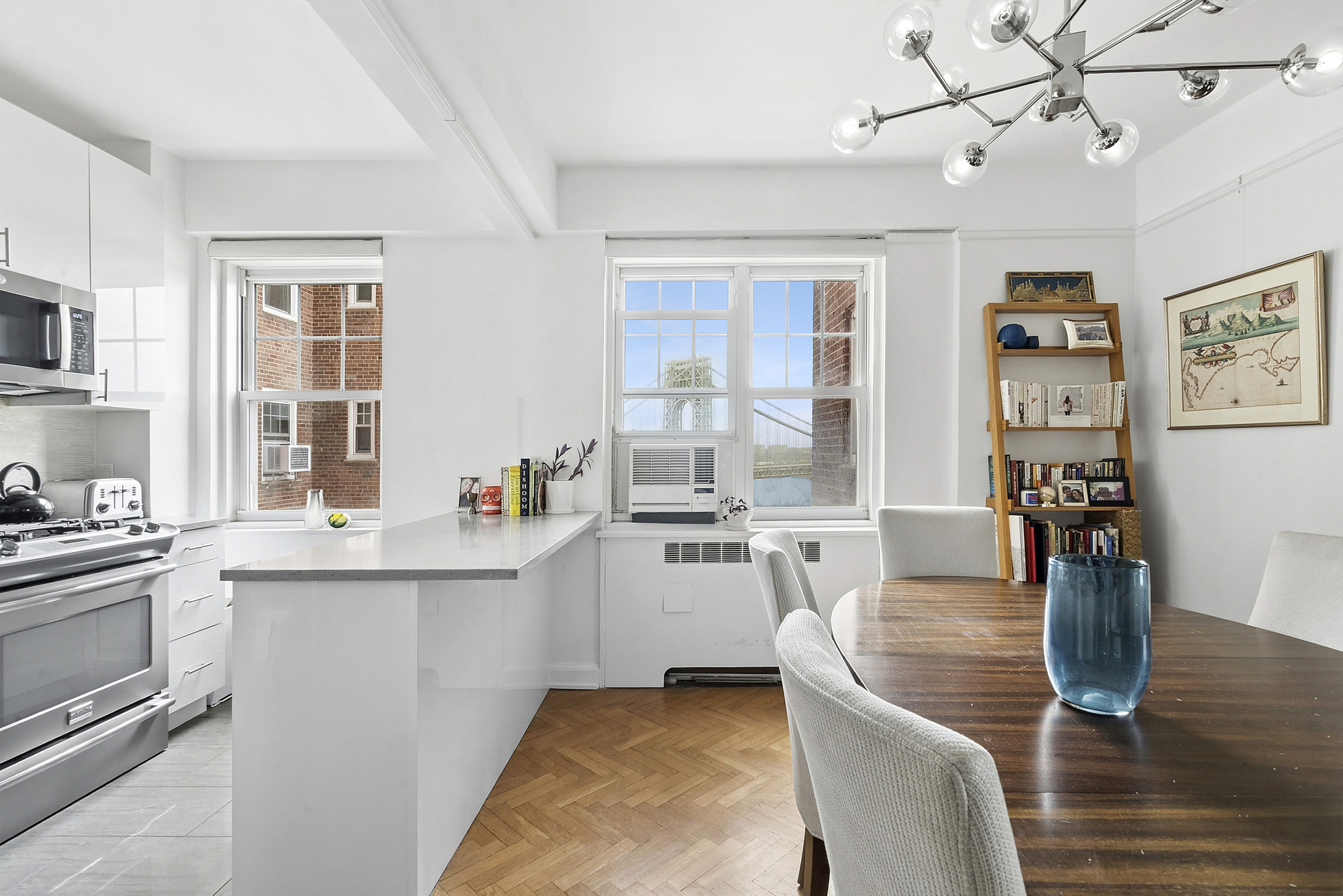 160 Cabrini Boulevard, Unit 89 Manhattan, NY 10033 - Photo 4 of 17 a kitchen with stainless steel appliances granite countertop a stove top oven a sink dishwasher and white cabinets with wooden floor
