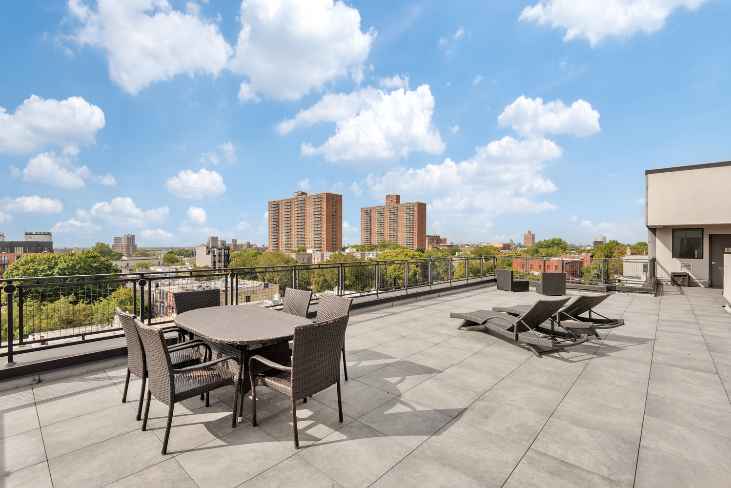 1325 Herkimer Street, Unit 404 Brooklyn, NY 11233 - Photo 6 of 7 a view of a terrace with furniture and a city view