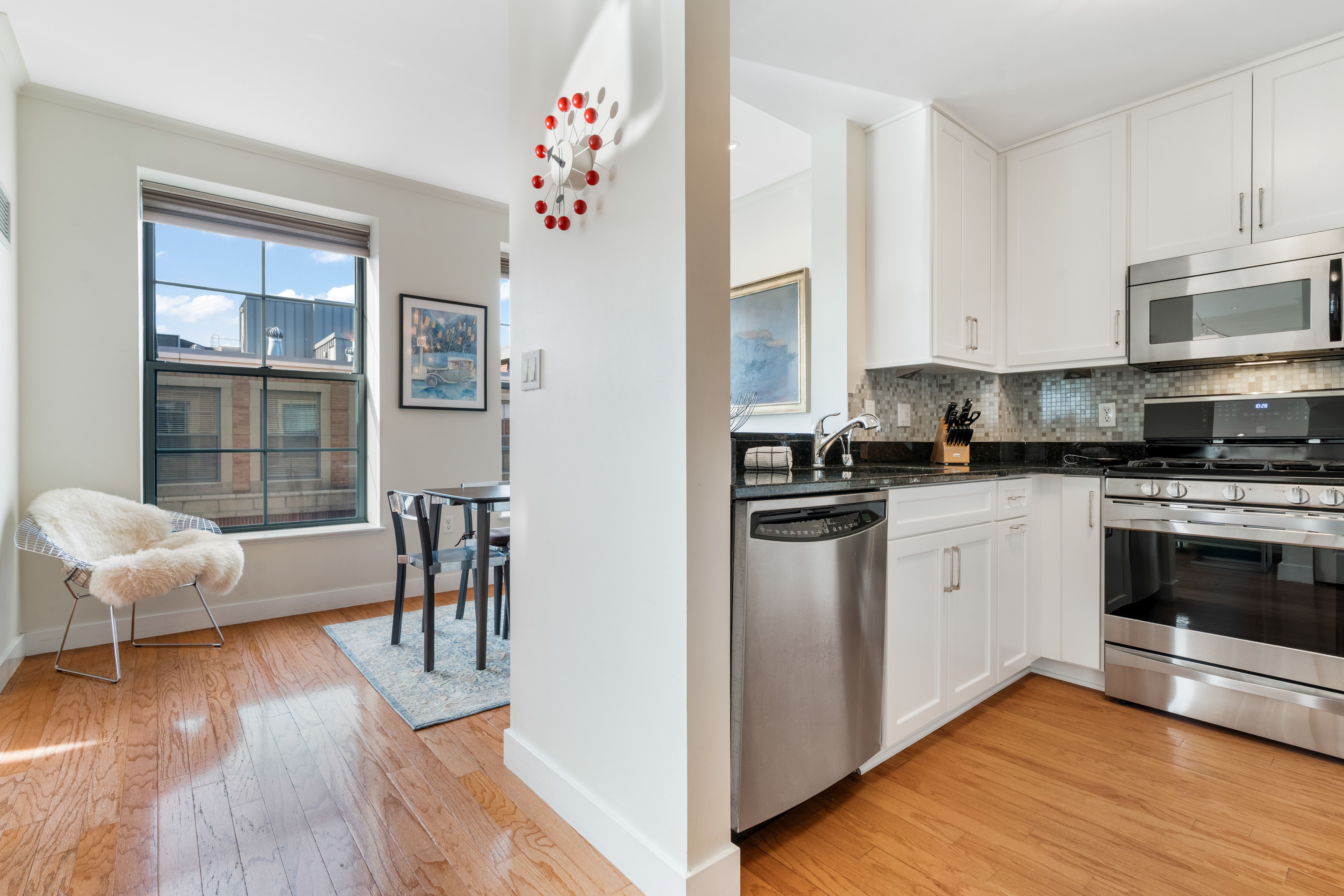 2 Rollins Street, Unit D601 Boston, MA 02118 - Photo 15 of 29 a kitchen with granite countertop a stove and white cabinets