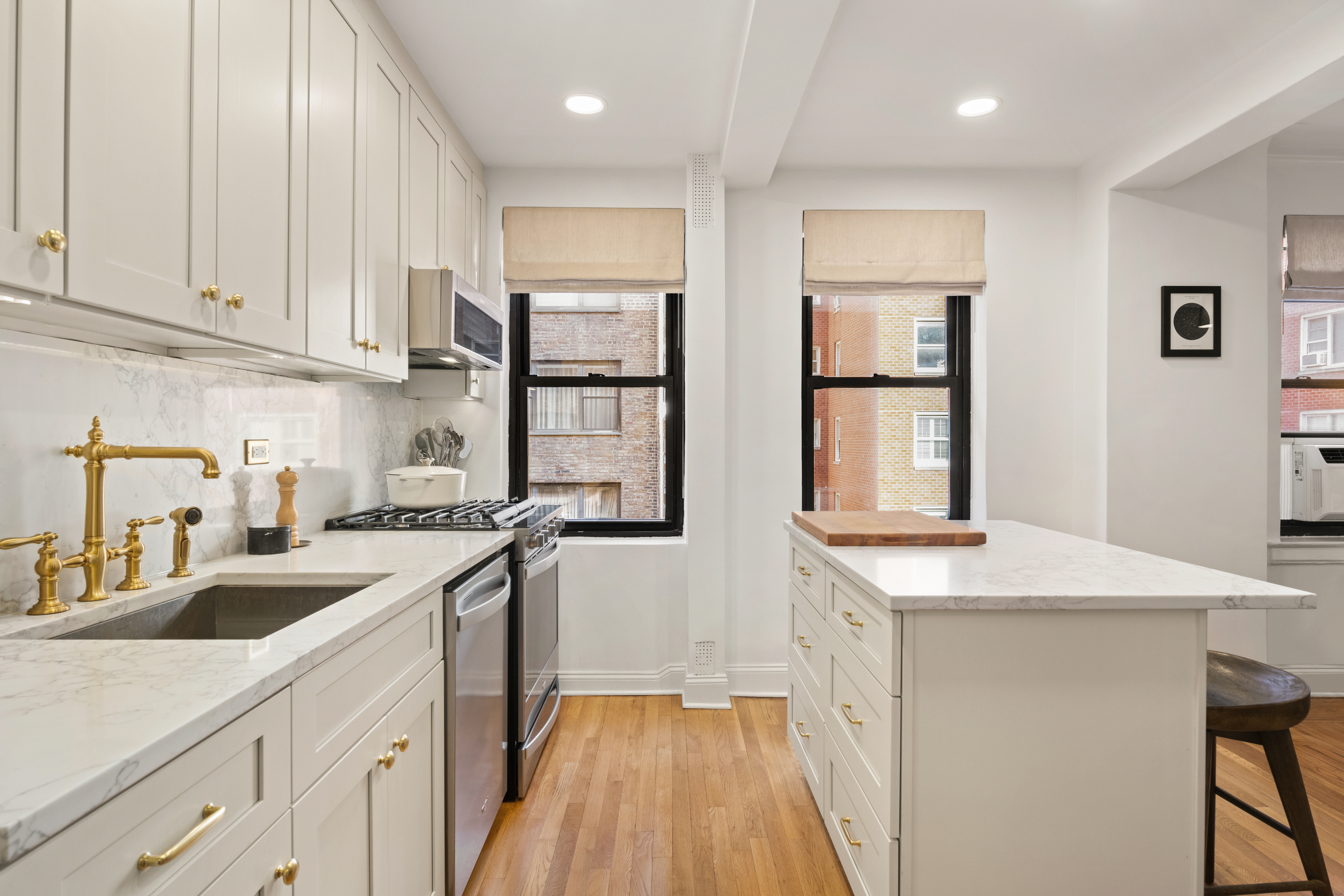 245 East 72nd Street, Unit 6F Manhattan, NY 10021 - Photo 7 of 9 a kitchen with a sink stove and cabinets