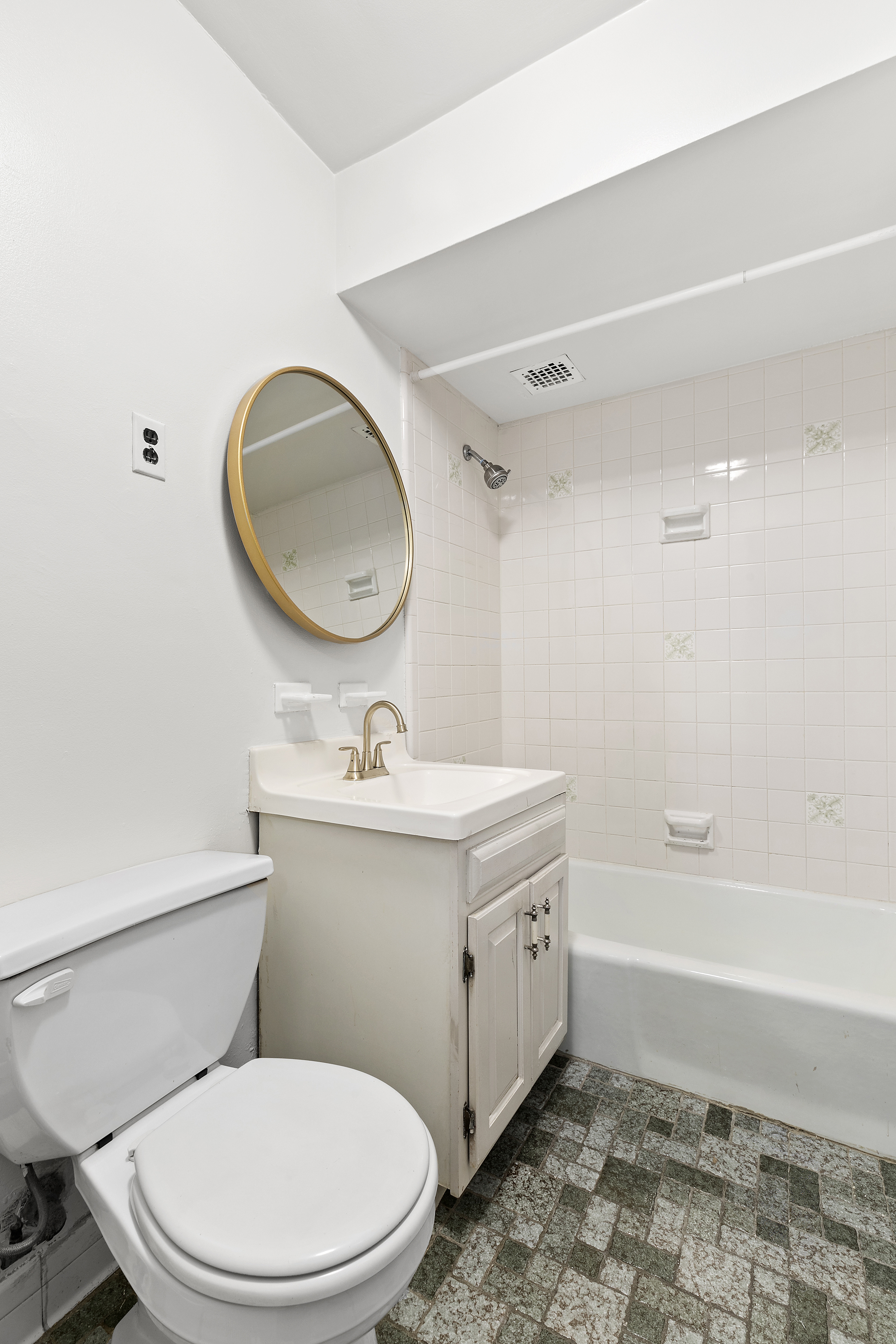 59 East 74th Street, Unit 8 Manhattan, NY 10021 - Photo 4 of 5 a bathroom with a sink a toilet and a mirror