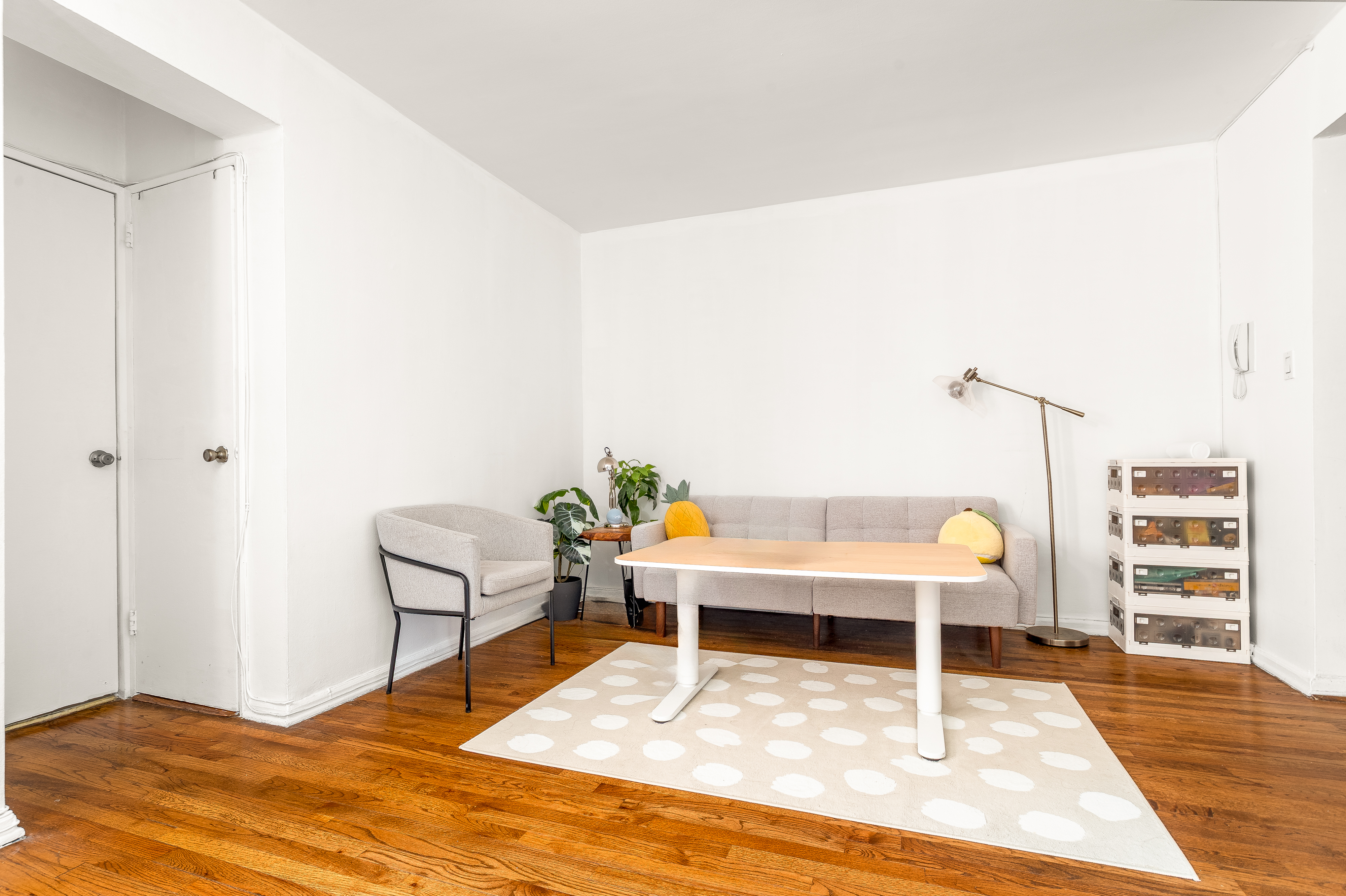 1420 York Avenue, Unit 6J Manhattan, NY 10021 - Photo 6 of 13 a living room with furniture a wooden floor and next to a window