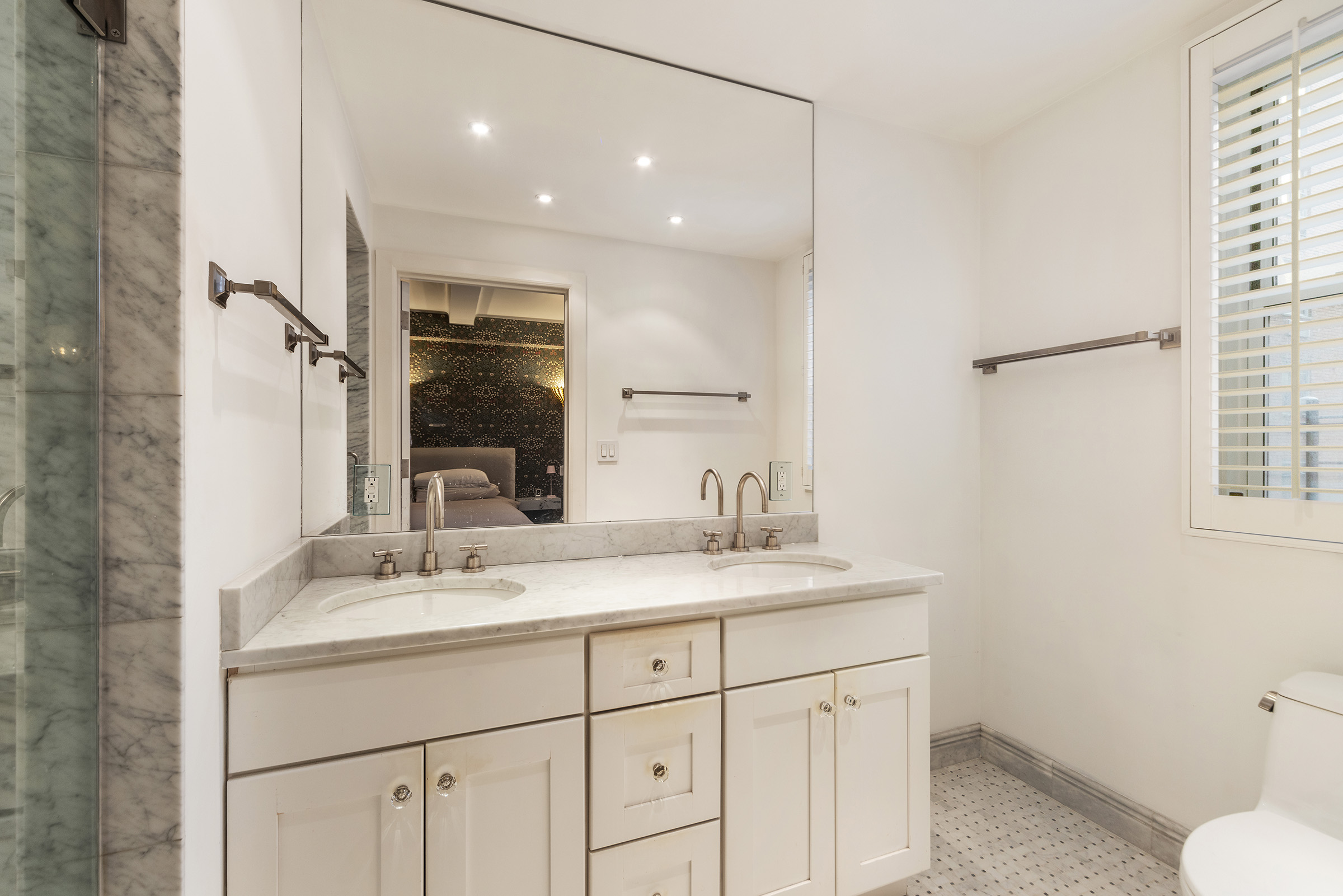 25 East 86th Street, Unit 3C Manhattan, NY 10028 - Photo 7 of 15 a bathroom with a sink toilet double vanity and shower